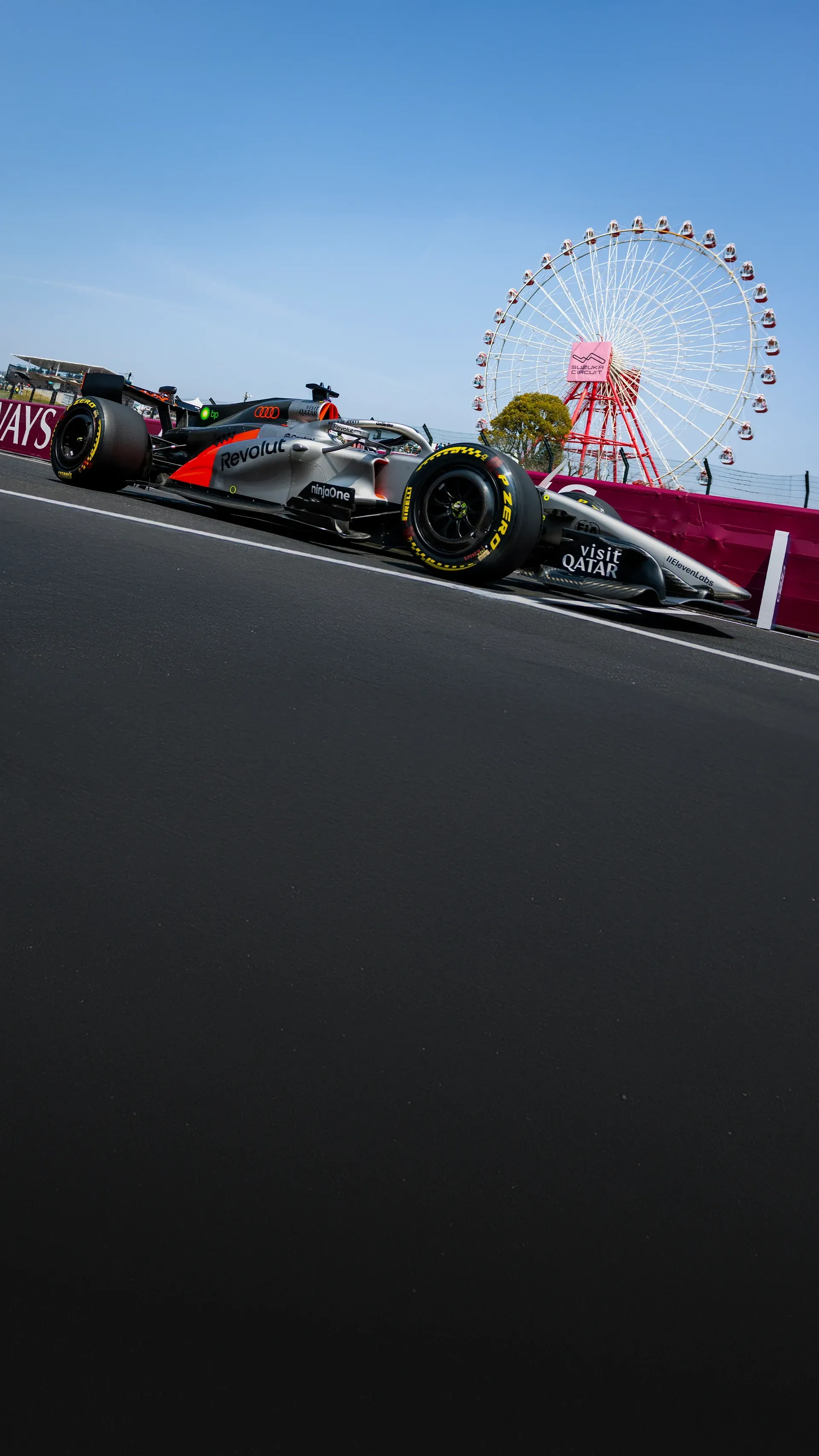 Gabriel Bortoleto in the Audi Revolut F1® Team car passes the Suzuka Circuit ferris wheel during track action.