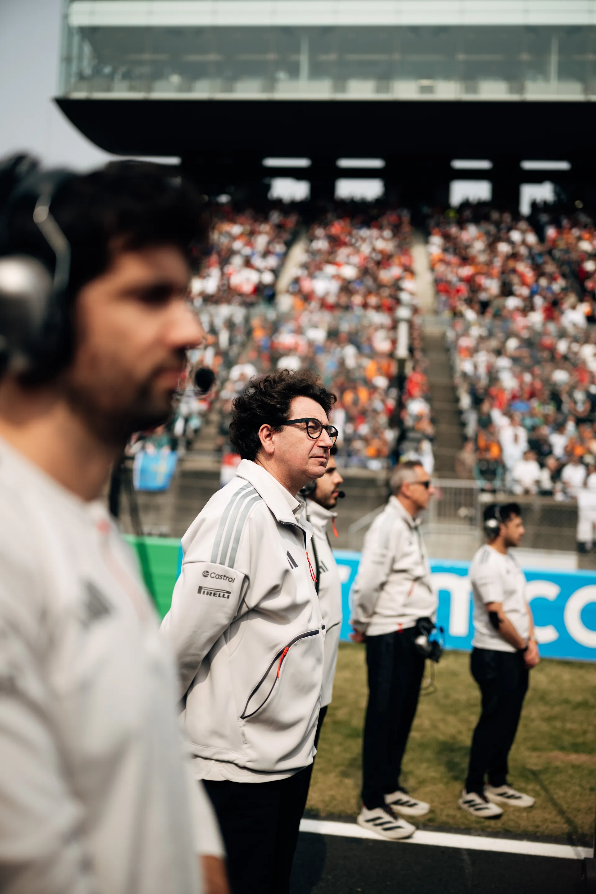 Mattia Binotto stands on the grid with Audi Revolut F1® Team staff before the race.