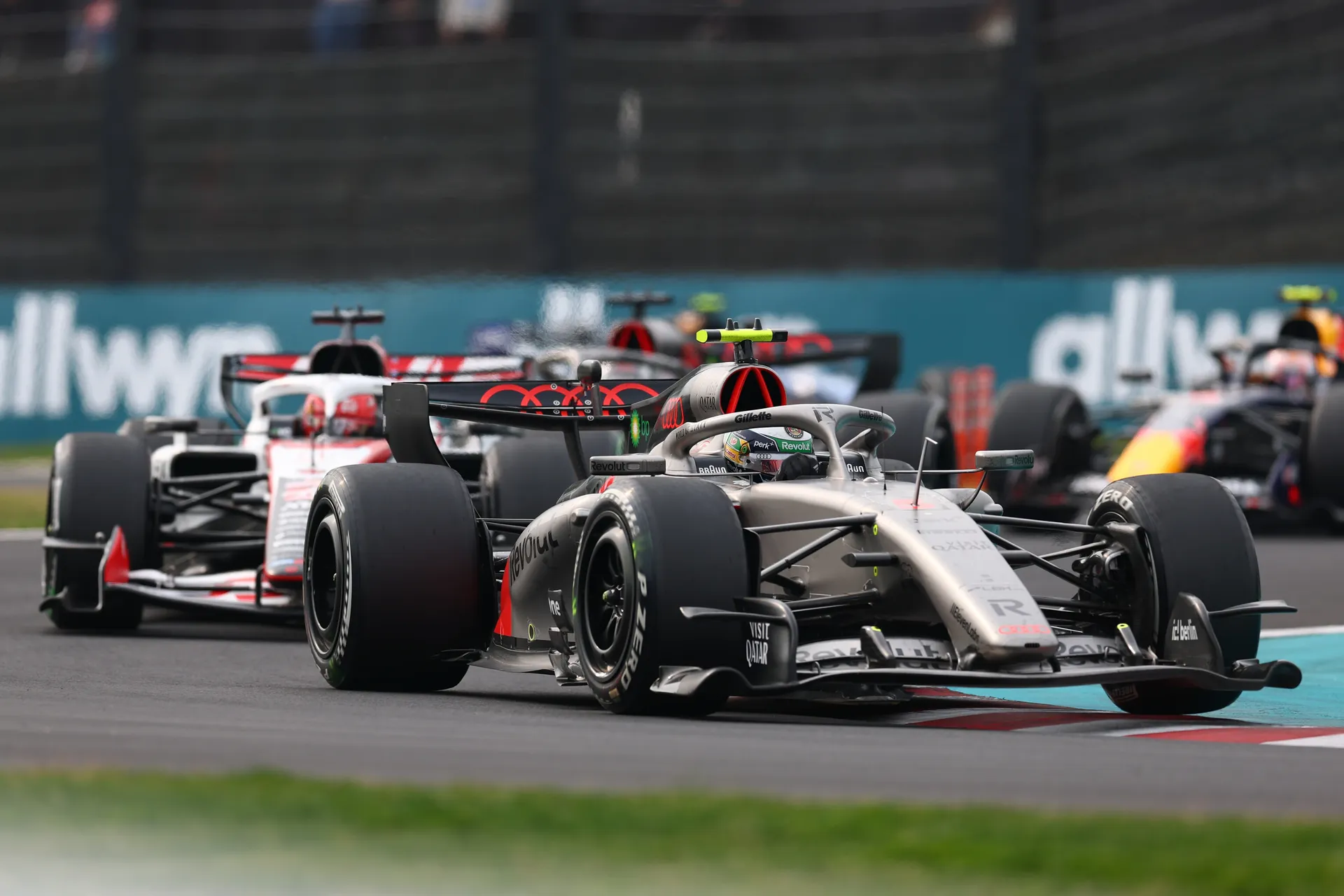 Gabriel Bortoleto drives the Audi Revolut F1® Team car through traffic during the Japanese Grand Prix, leading a group of cars through a Suzuka corner.