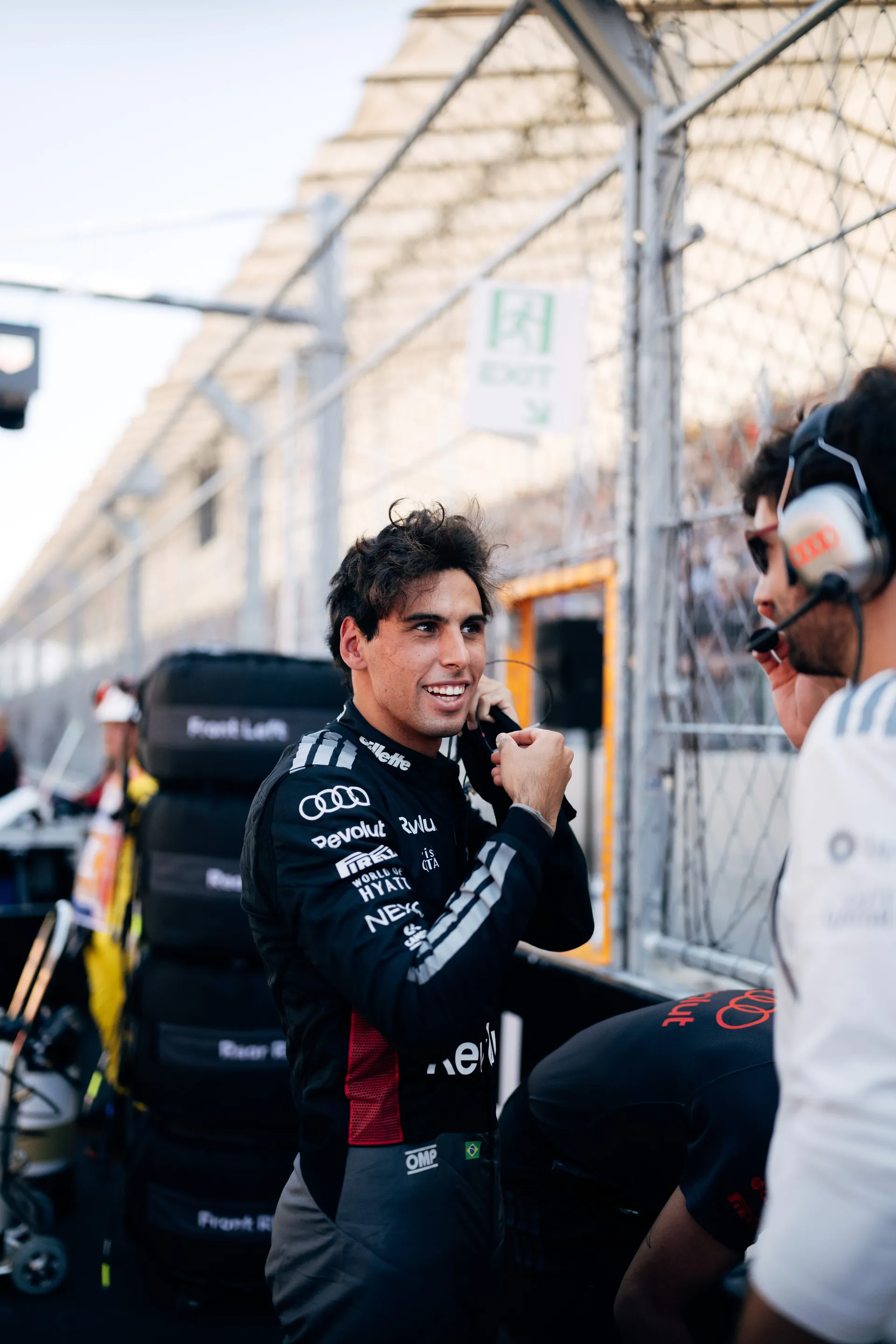 Gabriel Bortoleto of the Audi Revolut F1® Team talking to an engineer on the grid in Madrid