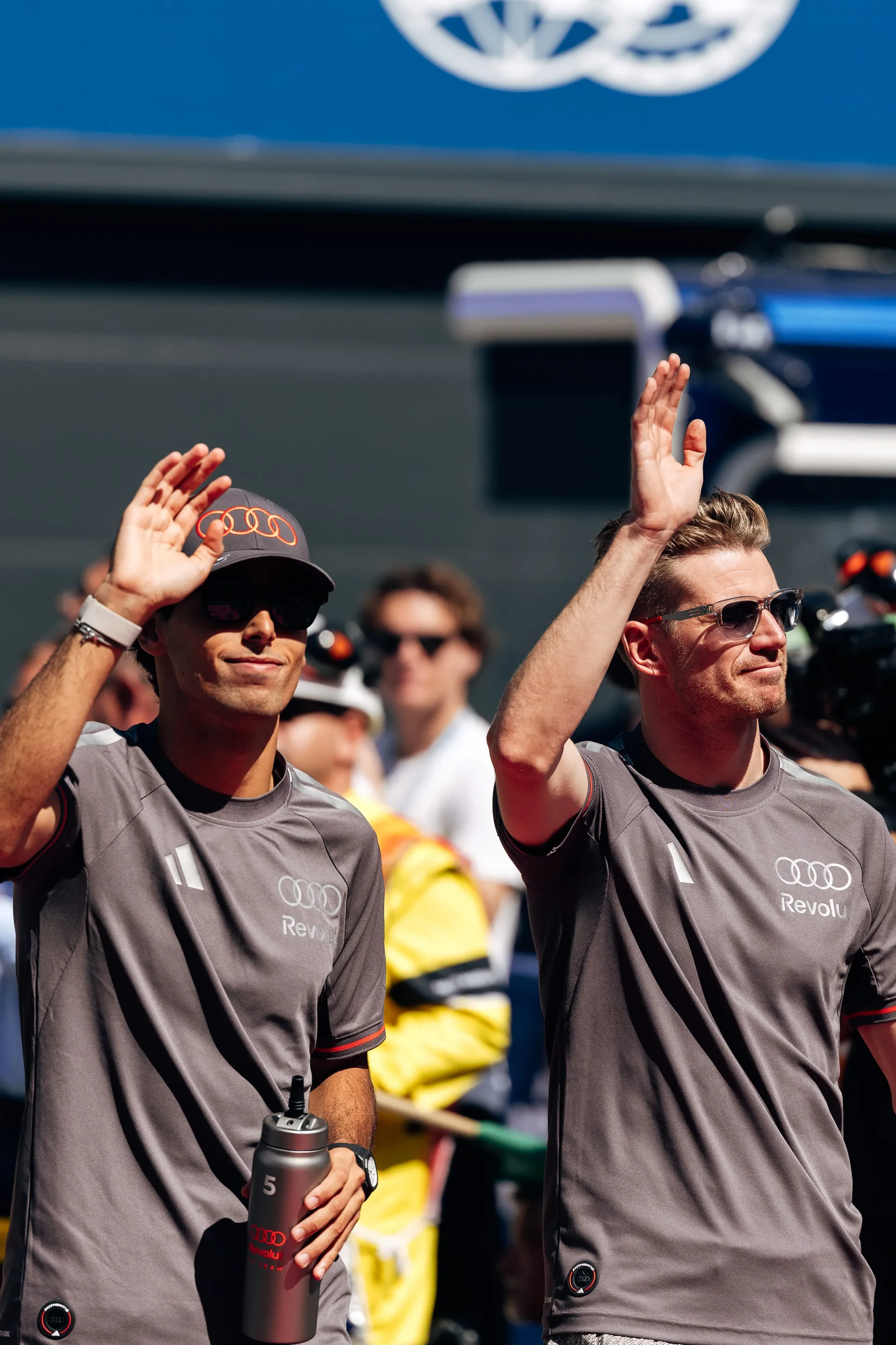 Gabriel Bortoleto and Nico Hulkenberg of the Audi Revolut F1® Team waving with raised hands in Madrid