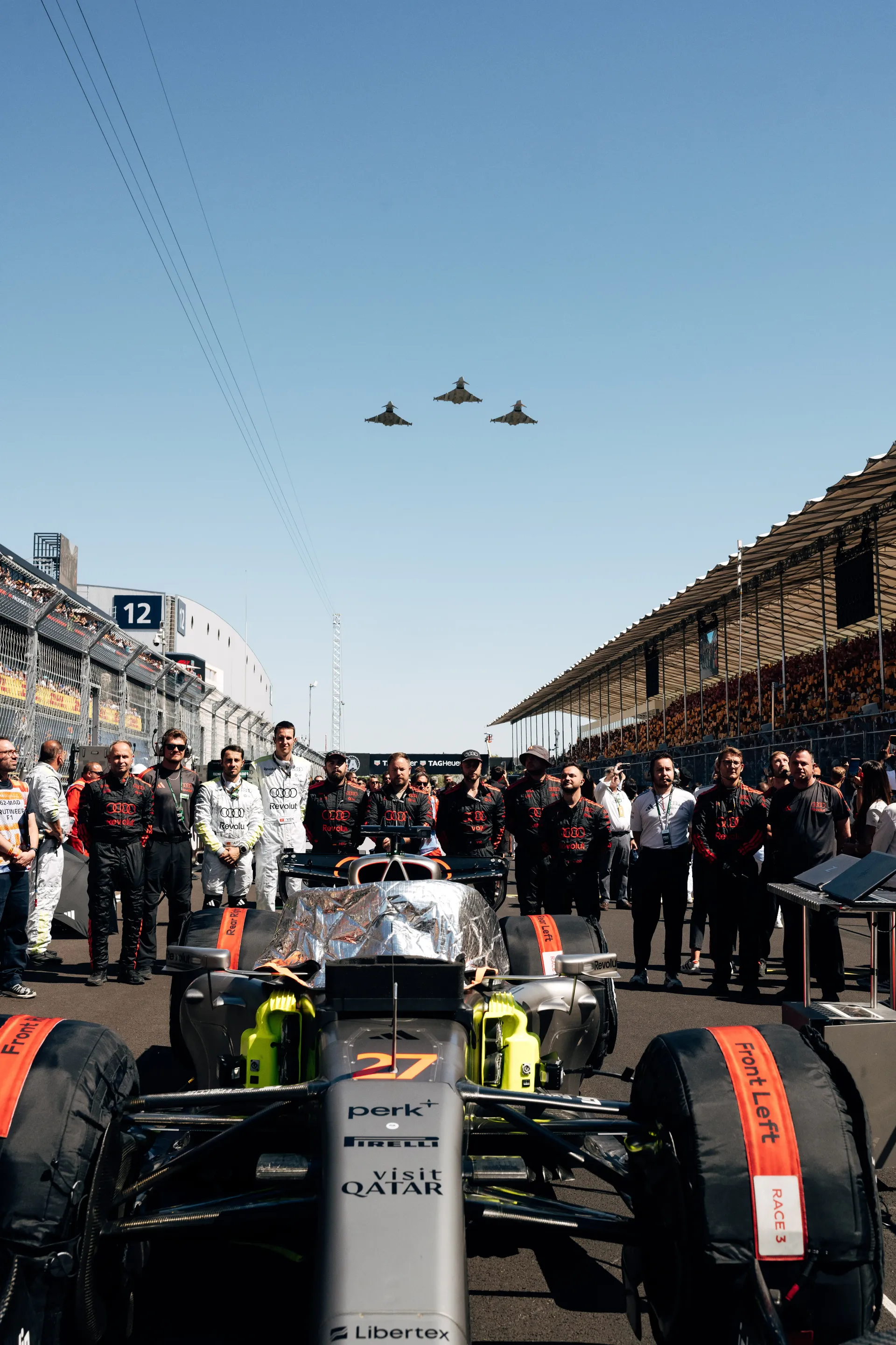 Car 27 of the Audi Revolut F1® Team on the grid in Madrid as three jets pass overhead