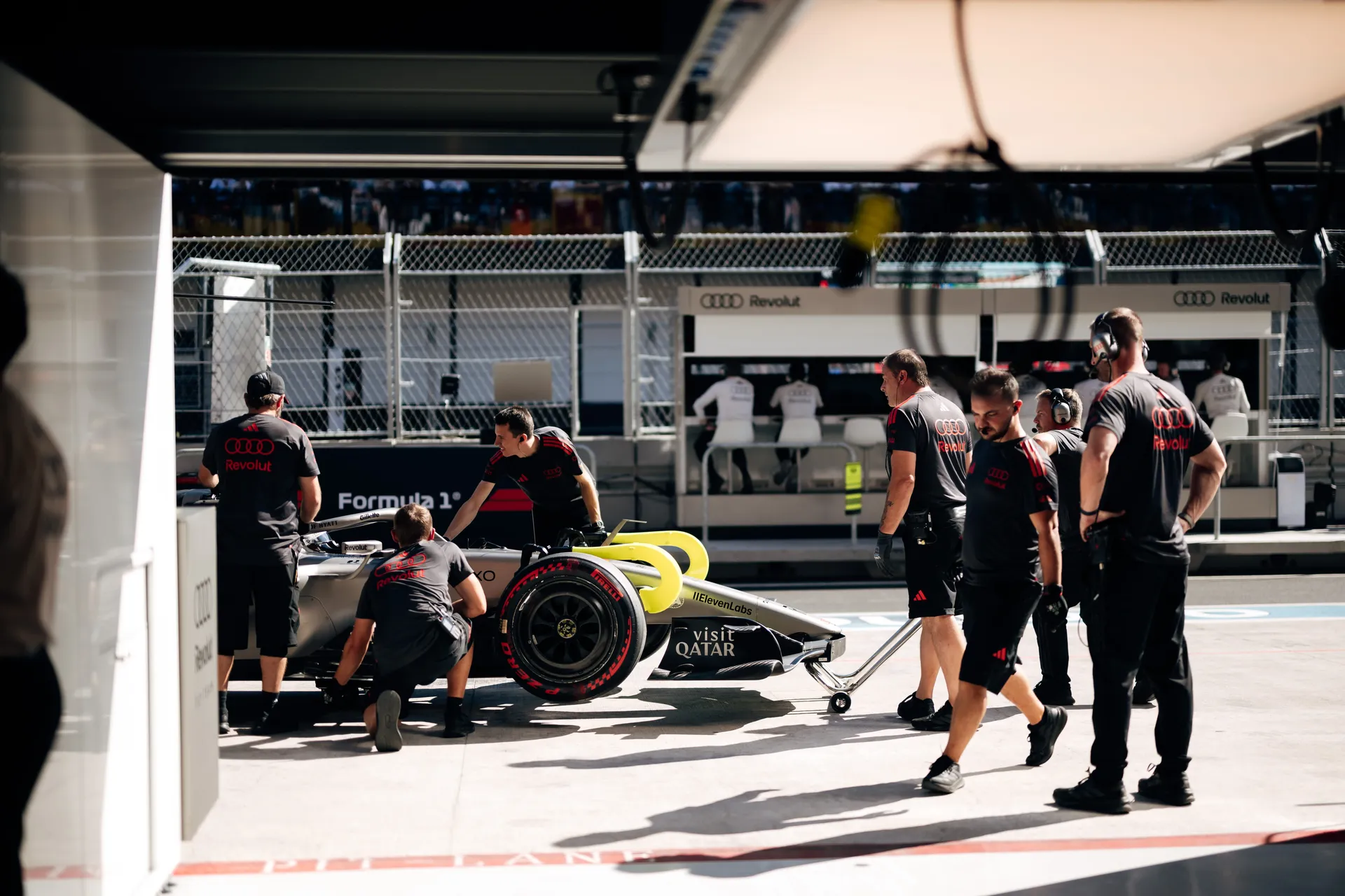 Audi Revolut F1® Team crew working around the car in the pit box in Madrid