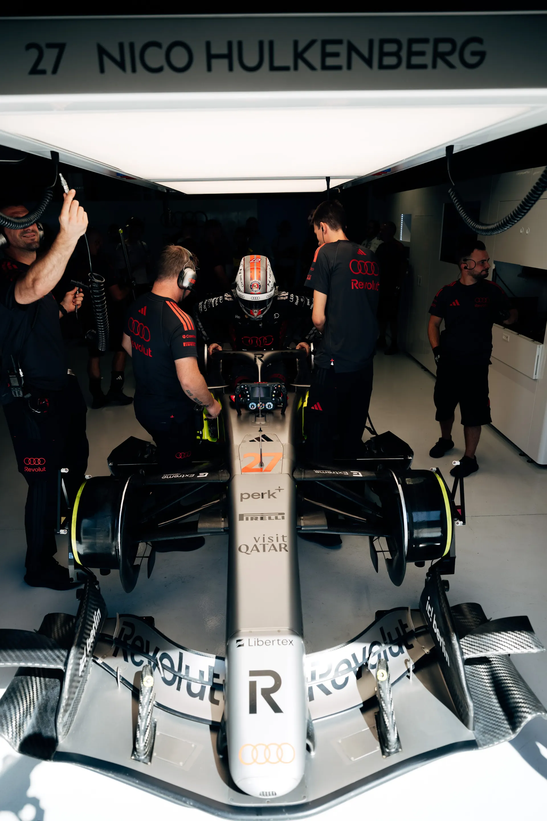 Nico Hulkenberg in the cockpit of the Audi Revolut F1® Team car under his garage signage in Madrid