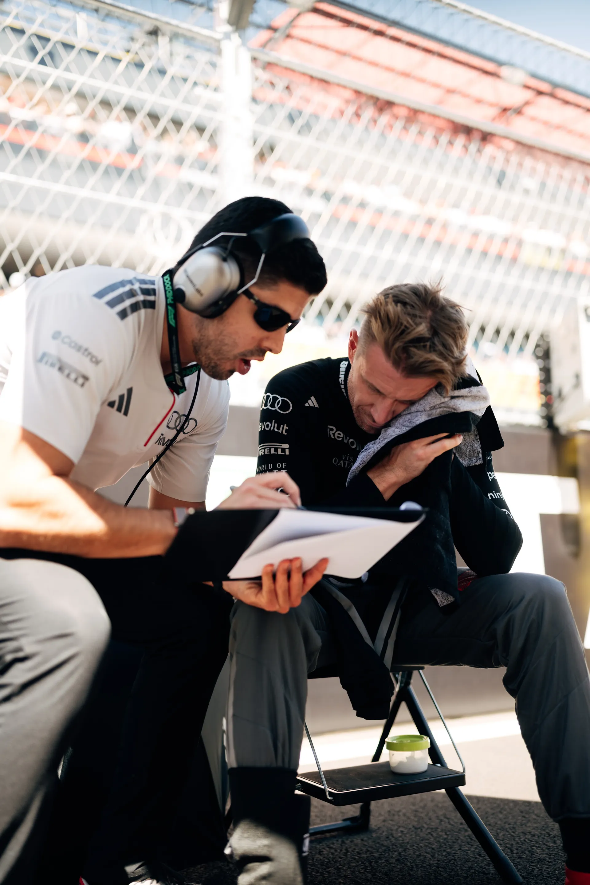 Nico Hulkenberg of the Audi Revolut F1® Team with an engineer and a clipboard before the race in Madrid
