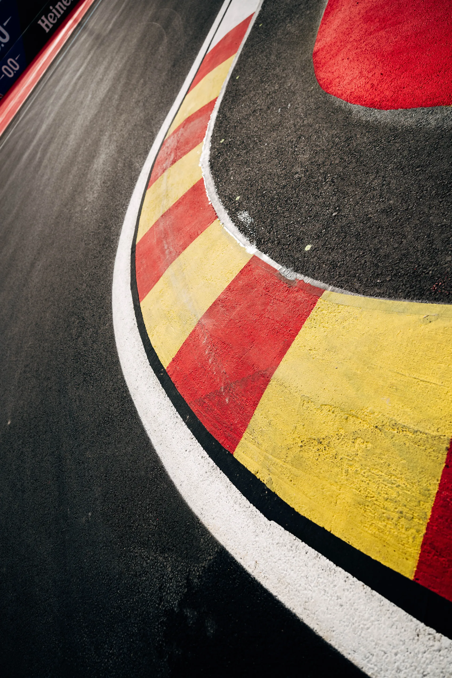 Close-up of a red and yellow kerb at the Madring ahead of the Audi Revolut F1® Team race weekend in Madrid