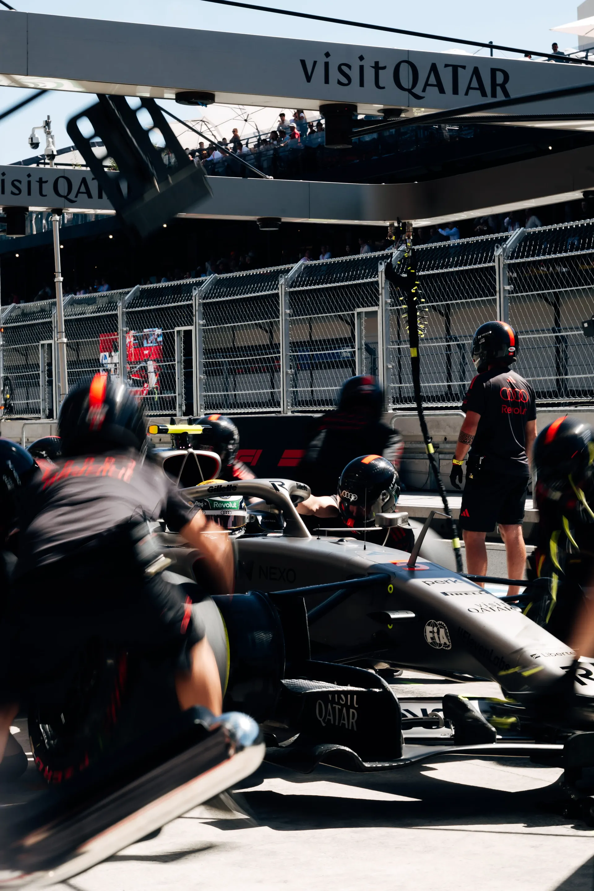 Audi Revolut F1® Team pit crew around the car during pit stop practice in the Madrid pit lane