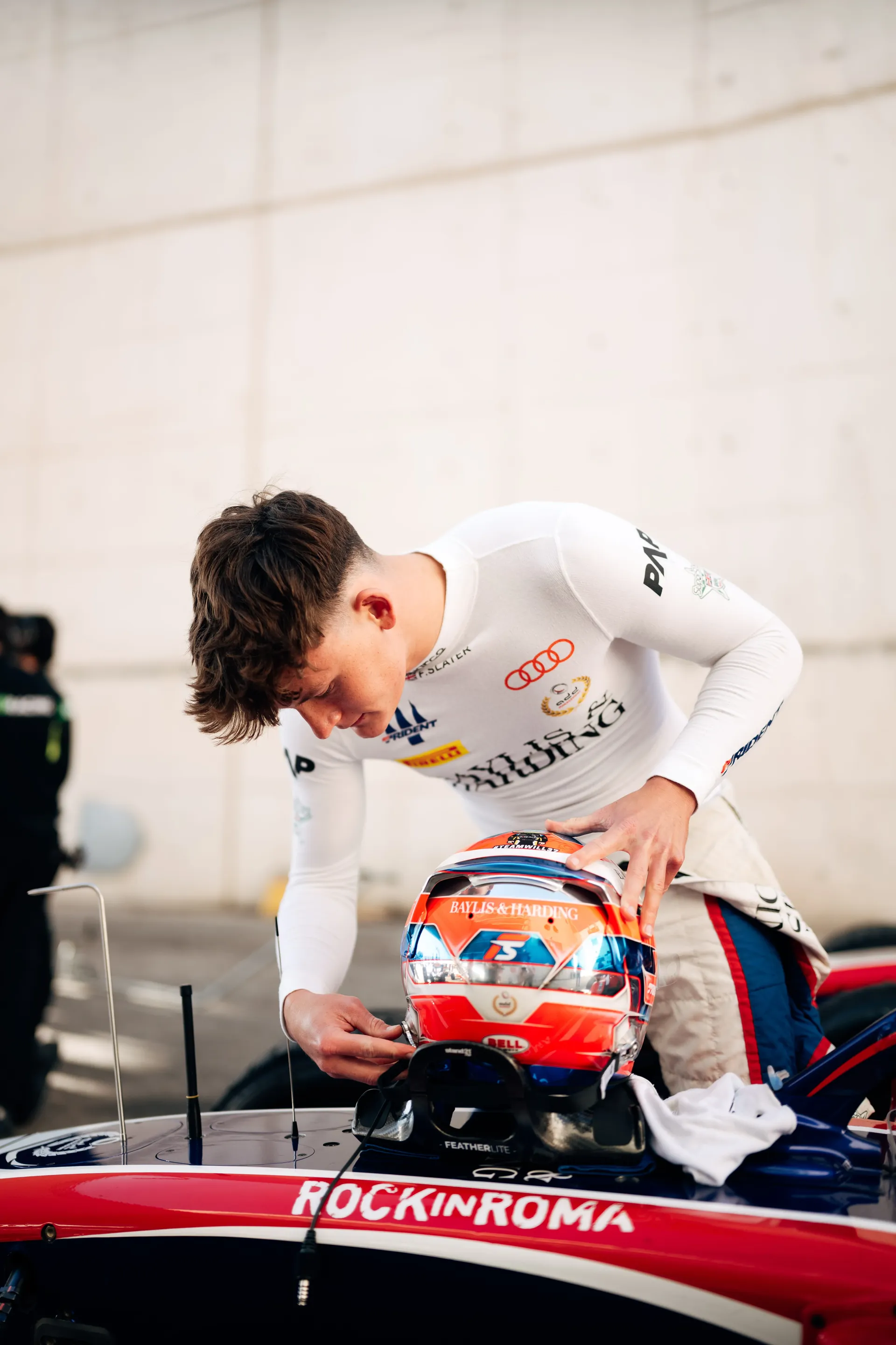 Freddie Slater, Audi rings on his race suit, with his helmet on his Formula 3 car in Madrid