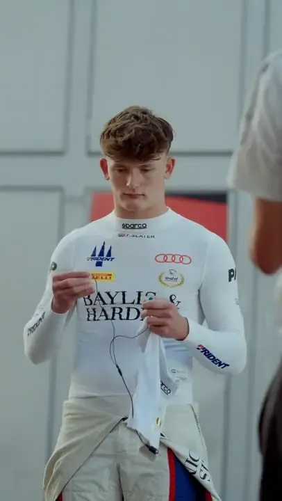 Freddie Slater in his race suit putting in earpieces before a session in Madrid