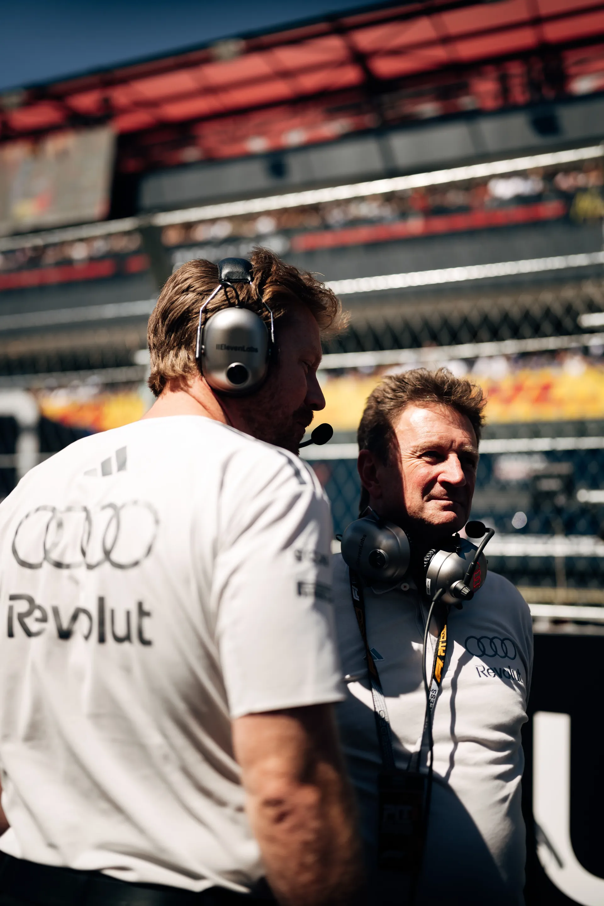 Two team members of the Audi Revolut F1® Team in conversation on the grid in Madrid