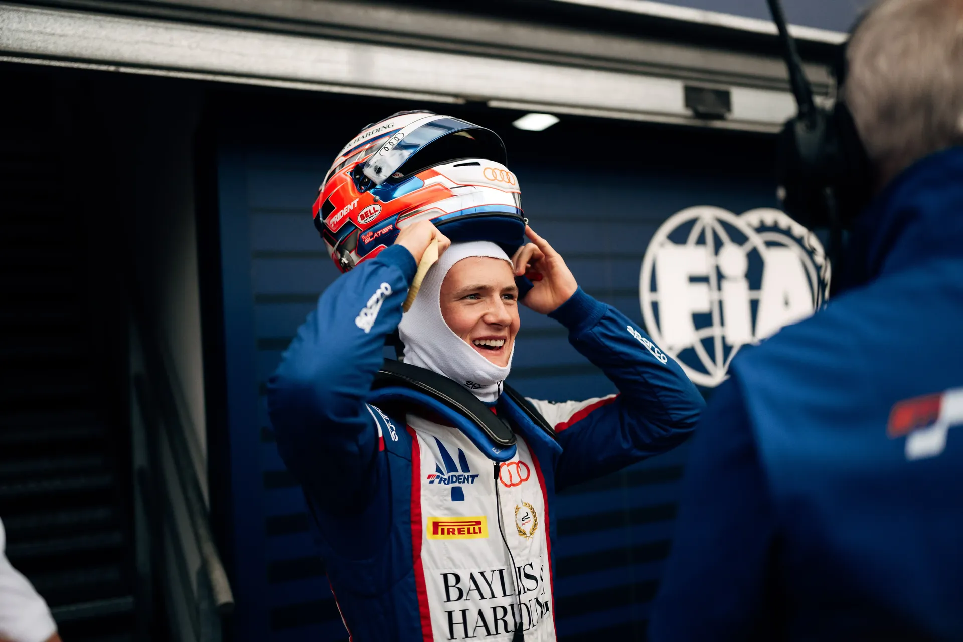 Freddie Slater lifts his helmet into place while preparing to leave the garage for track action during the Monaco Formula 3 weekend.