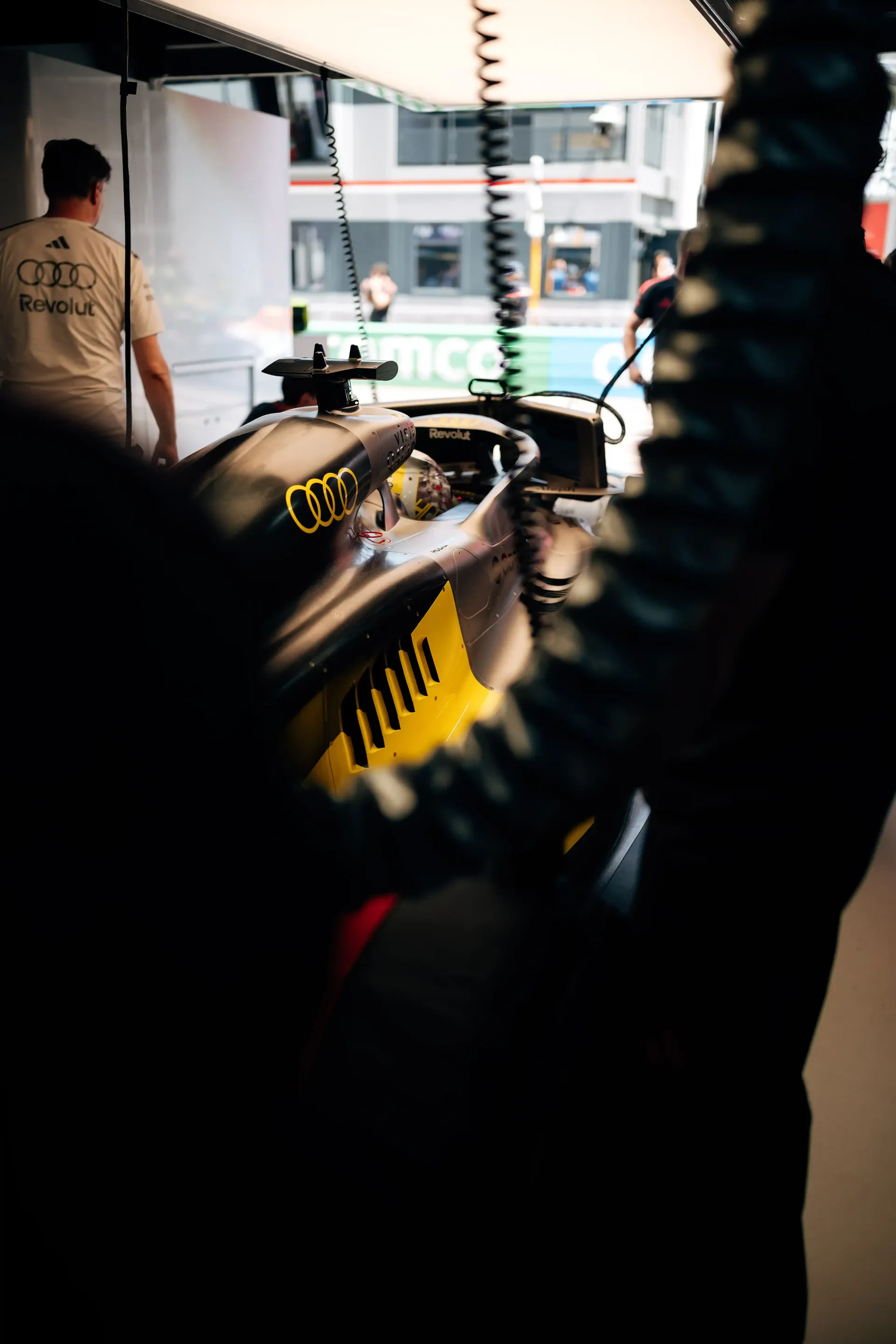Audi Revolut F1® Team members work around the F1® car inside the Monaco pit lane garage.