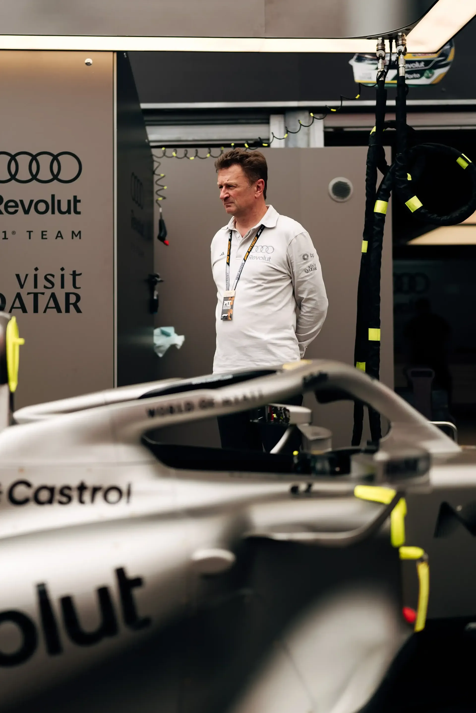 Audi Revolut F1® Team driving director Allan McNish stand beside the F1® car R26 in the Monaco pit garage during FP1 preparations.
