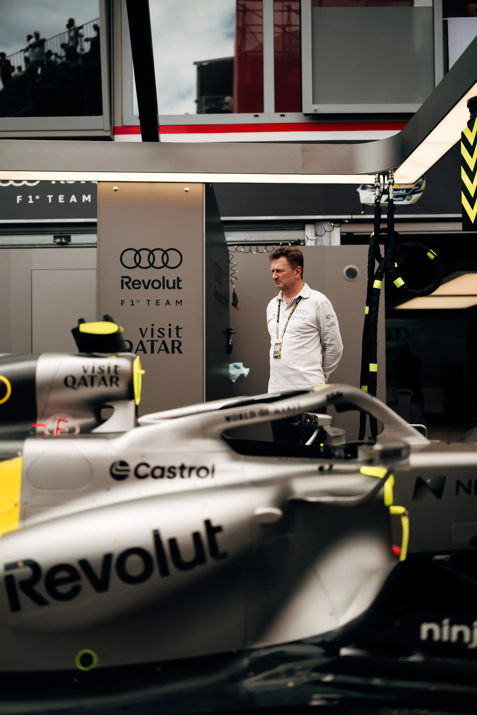 Audi Revolut F1® Team driving director Allan McNish stand beside the F1® car R26 in the Monaco pit garage during FP1 preparations.