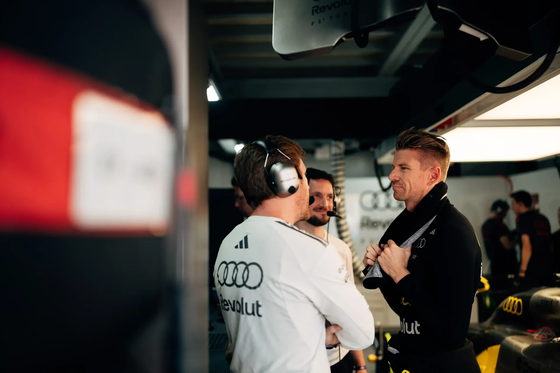 Audi Revolut F1® Team crew discuss preparations beside the F1® car in the Monaco garage before FP1.