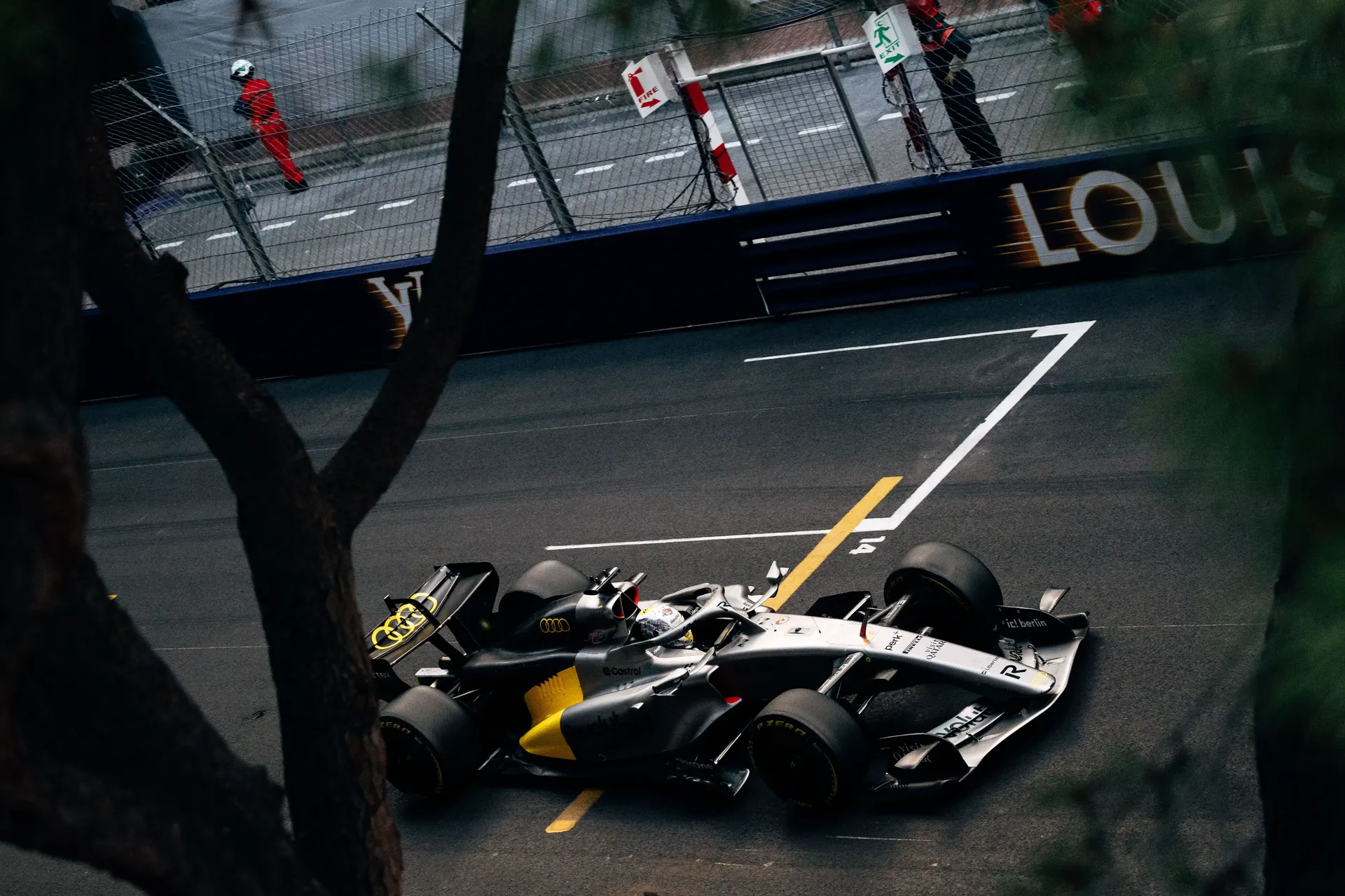 Audi Revolut F1® Team Formula 1 car navigating a corner from an elevated trackside perspective.