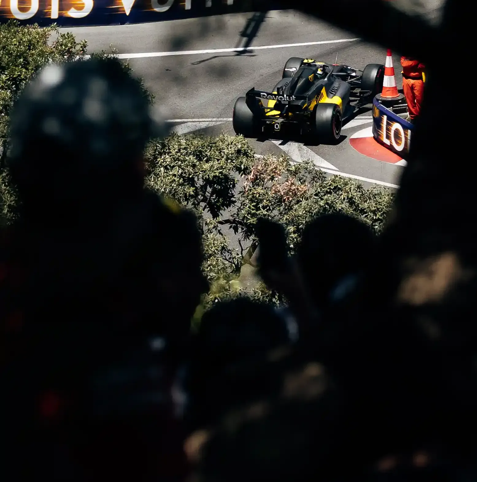 Audi Revolut F1® Team car R26 passes through a Monaco street circuit section viewed through spectators in the foreground.
