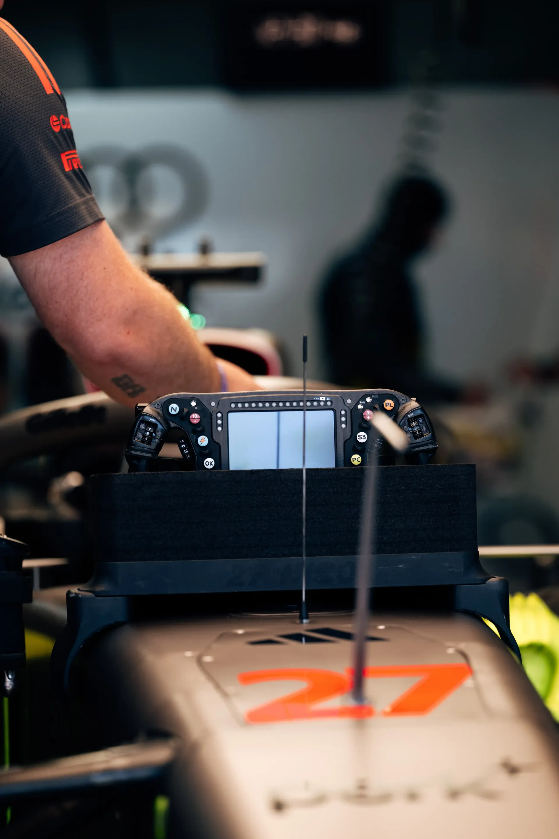 Close-up of the Audi Revolut F1® Team Formula 1 car R26 nose section with team members working around it.