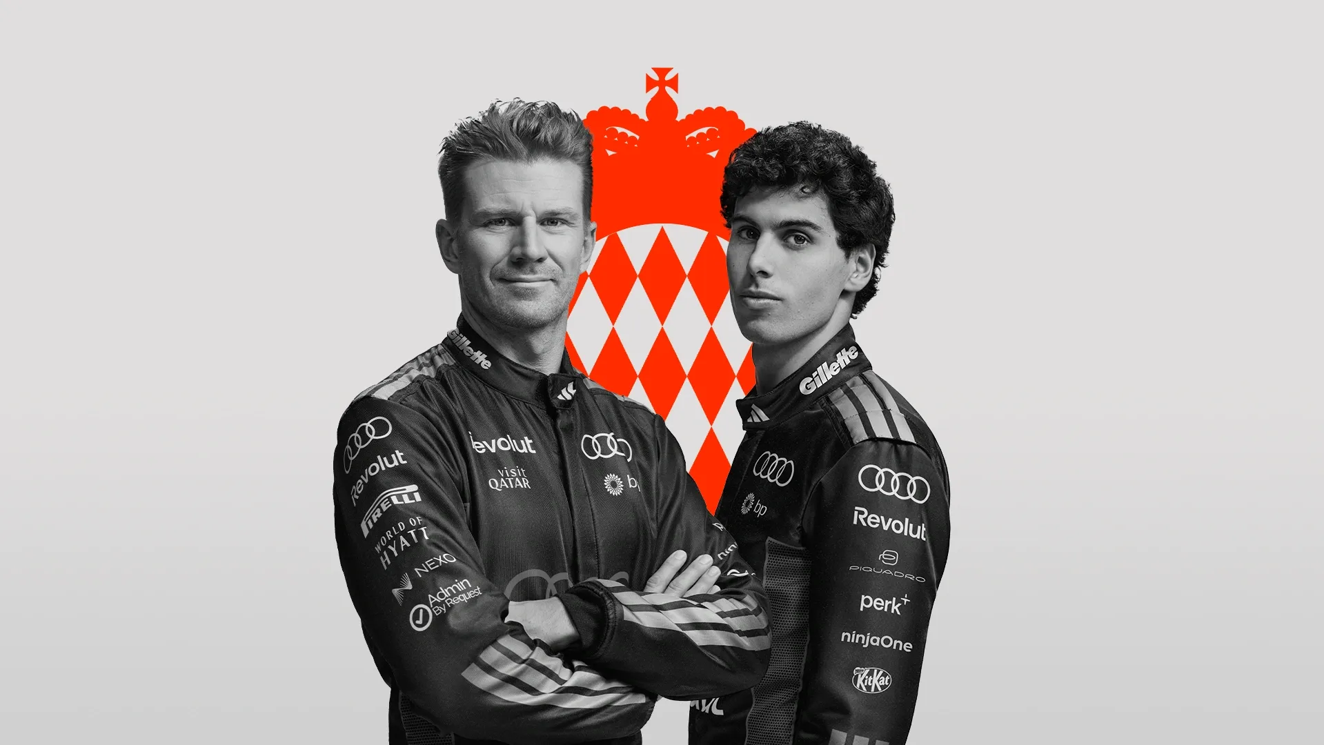 Nico Hulkenberg and Gabriel Bortoleto dirvers at the Audi Revolut F1® Team posing side by side in front of the Moanco Flagin the Studio