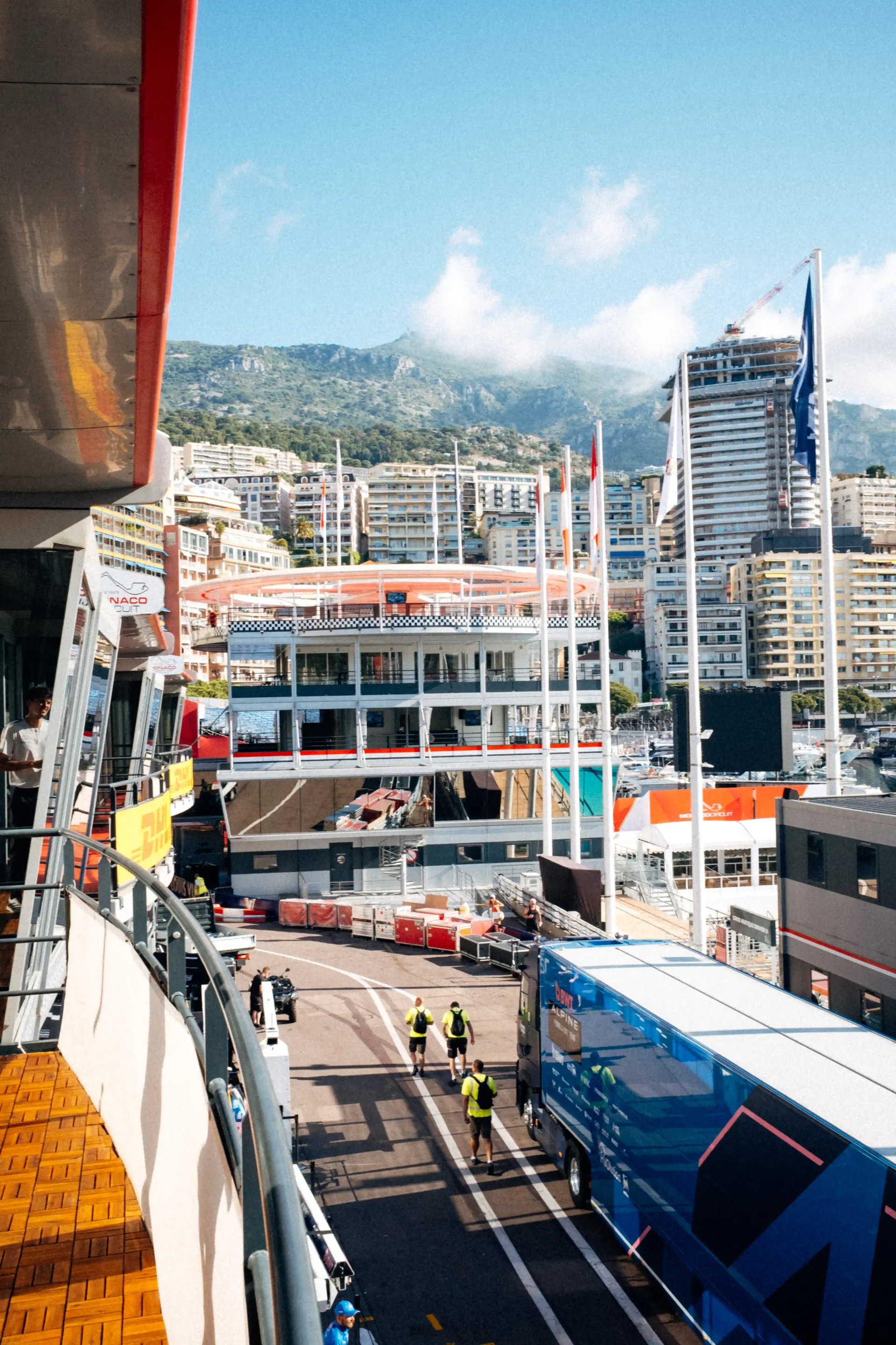 Marina scene in Monaco featuring yachts docked beside modern waterfront architecture.