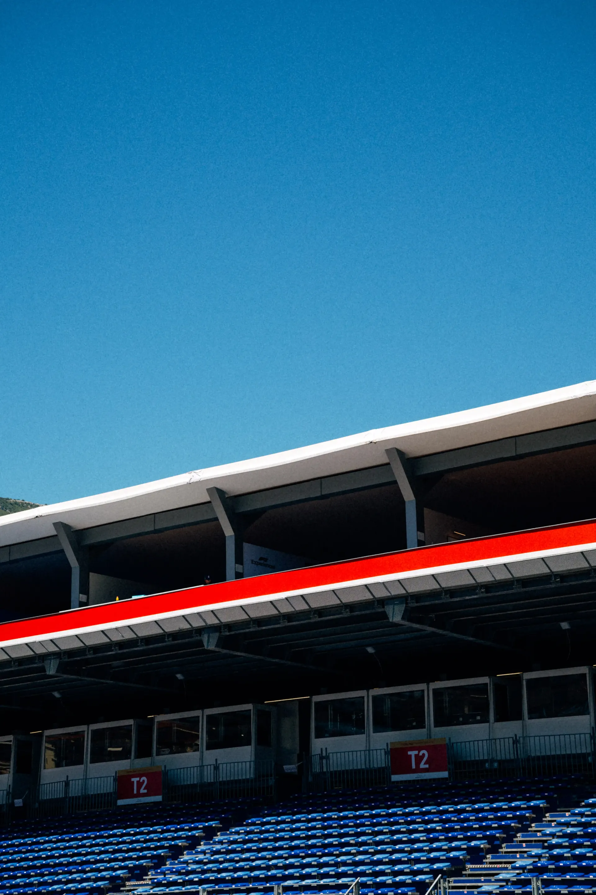 Modern architectural structure with sweeping curved rooflines against a blue sky.