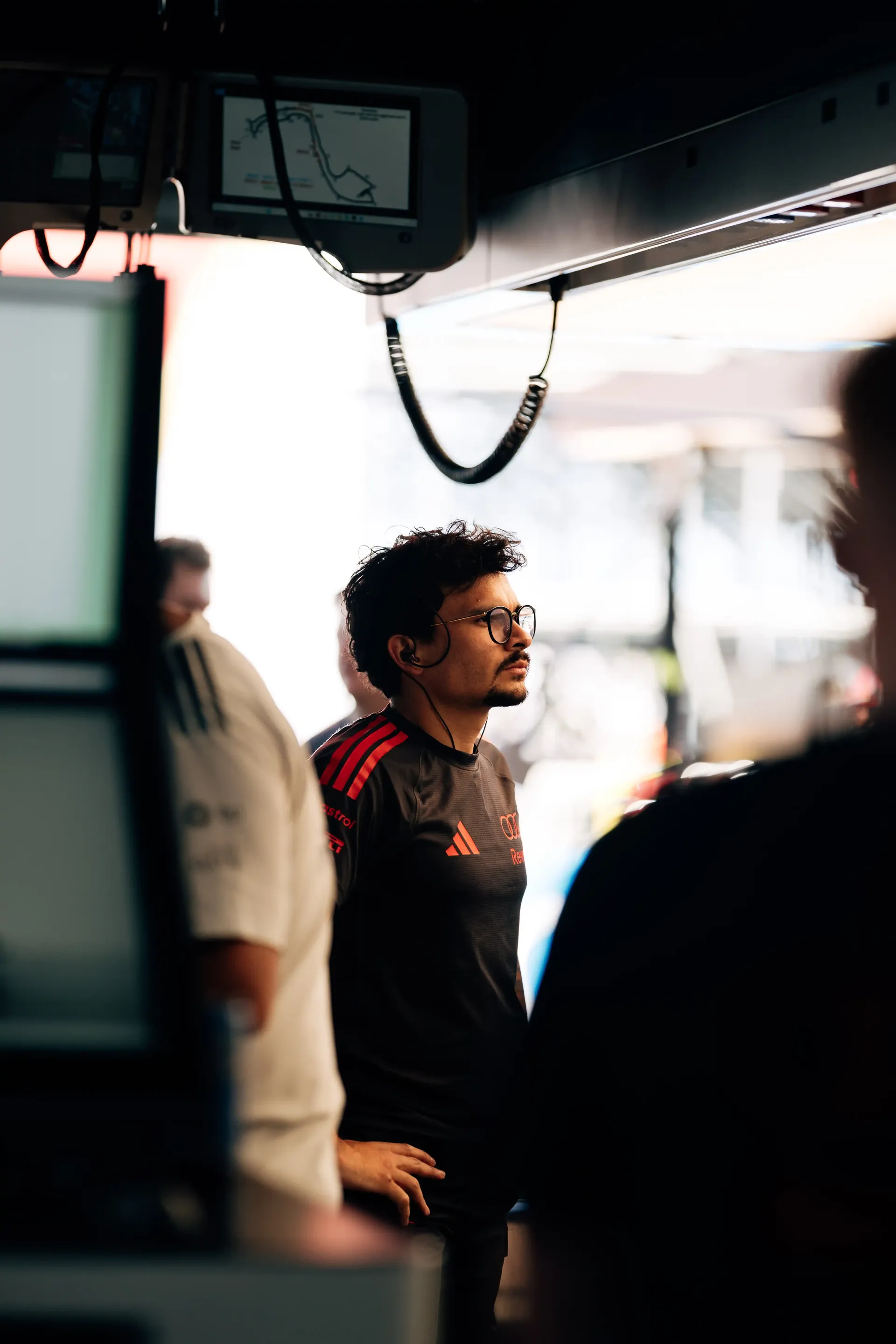 Audi Revolut F1® Team machanic watches activity from inside the garage during qualifying.