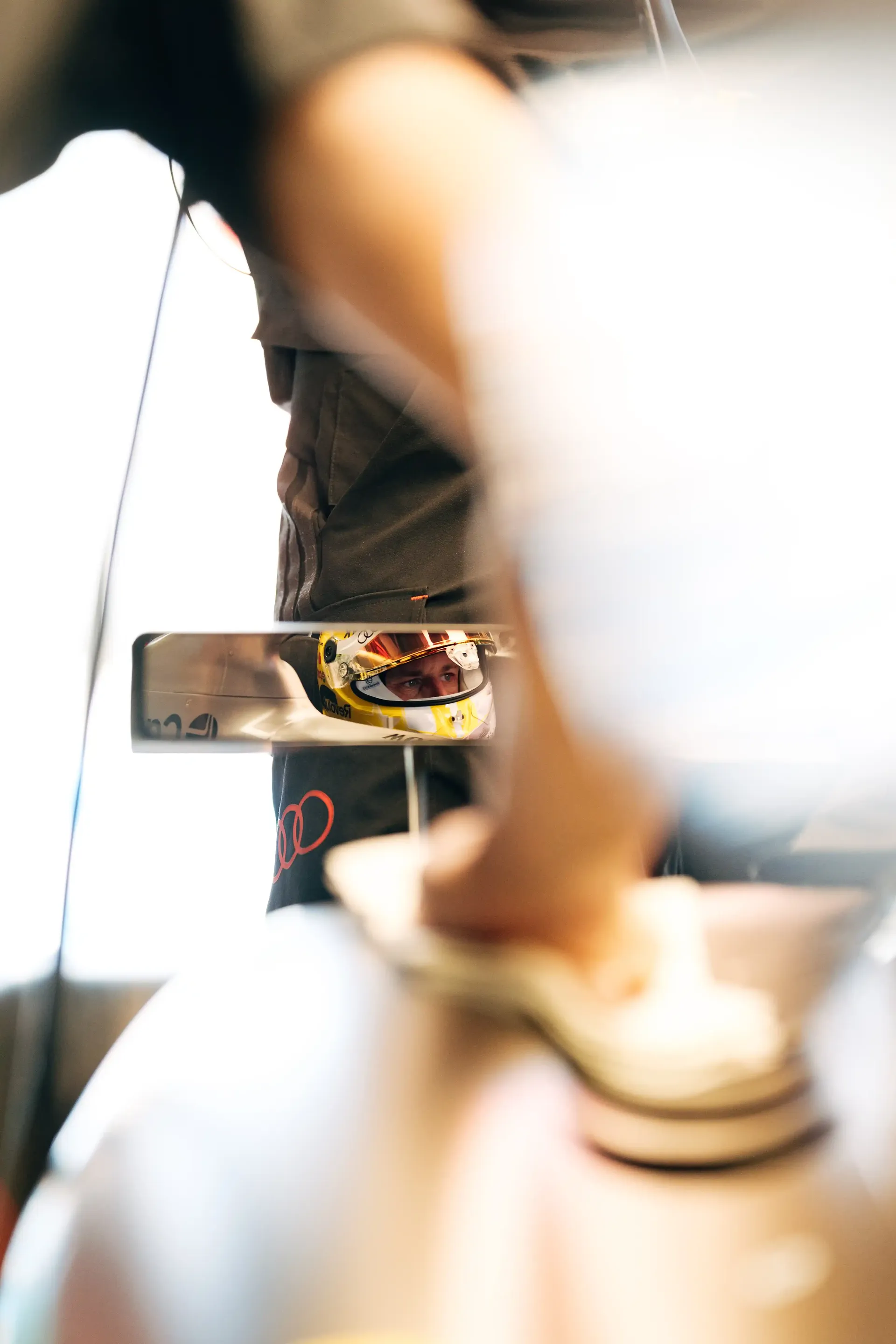 Artistic close-up of an Audi Revolut F1® Team helmet with a soft-focus foreground.