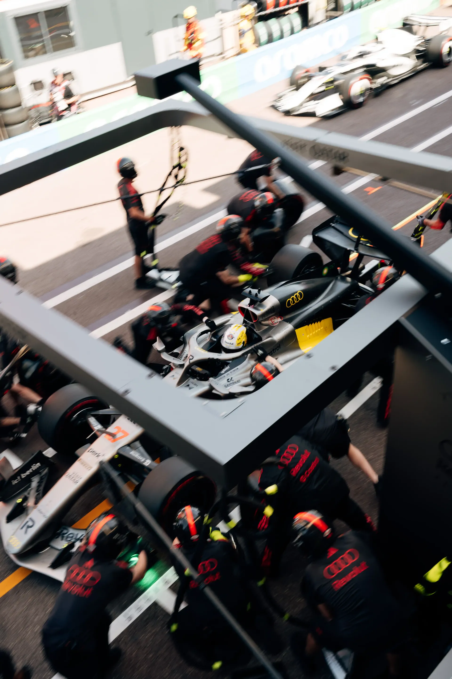 Overhead view of the Audi Revolut F1® Team pit box with crew members and race car during qualifying.