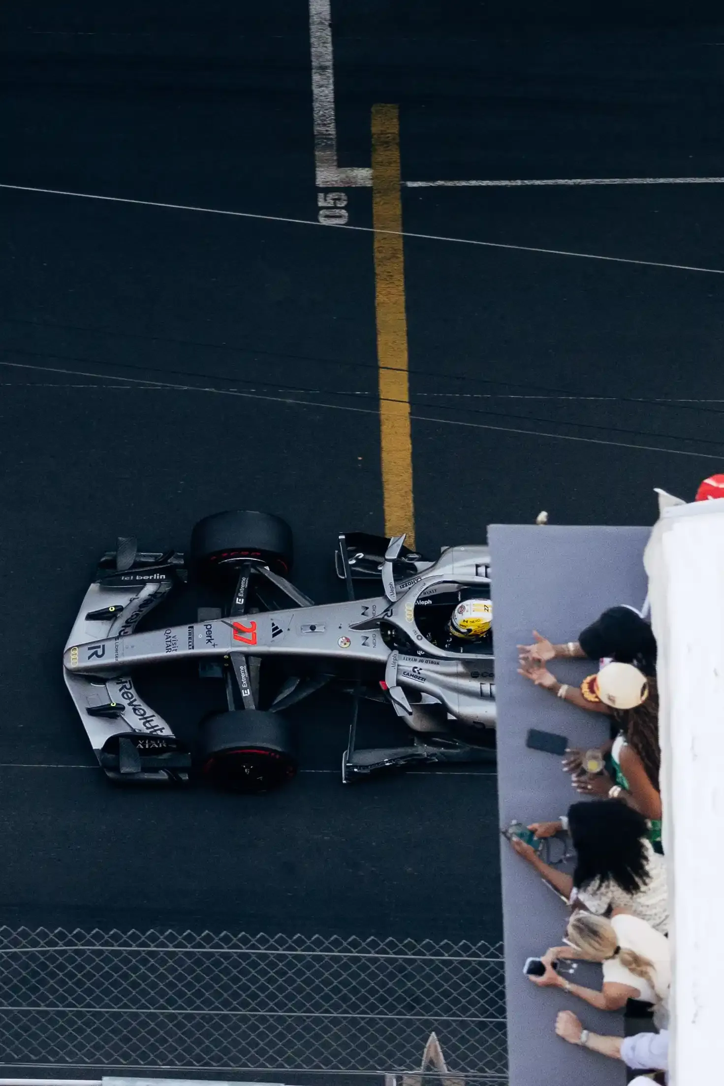 Overhead view of an Audi Revolut F1® Team race car R26 driving through the streets of Monaco during qualifying.