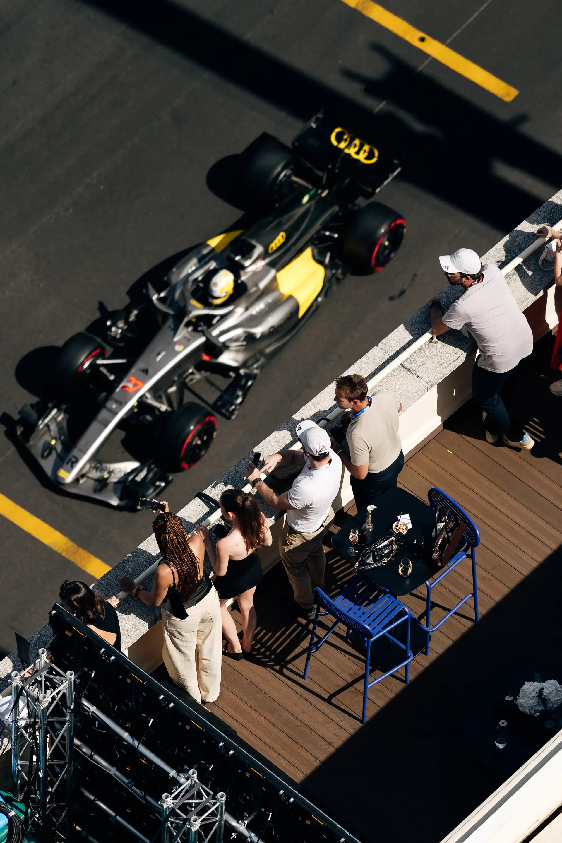 Aerial view of the Audi Revolut F1® Team pit area with crew members surrounding the race car during Monaco Grand Prix qualifying.