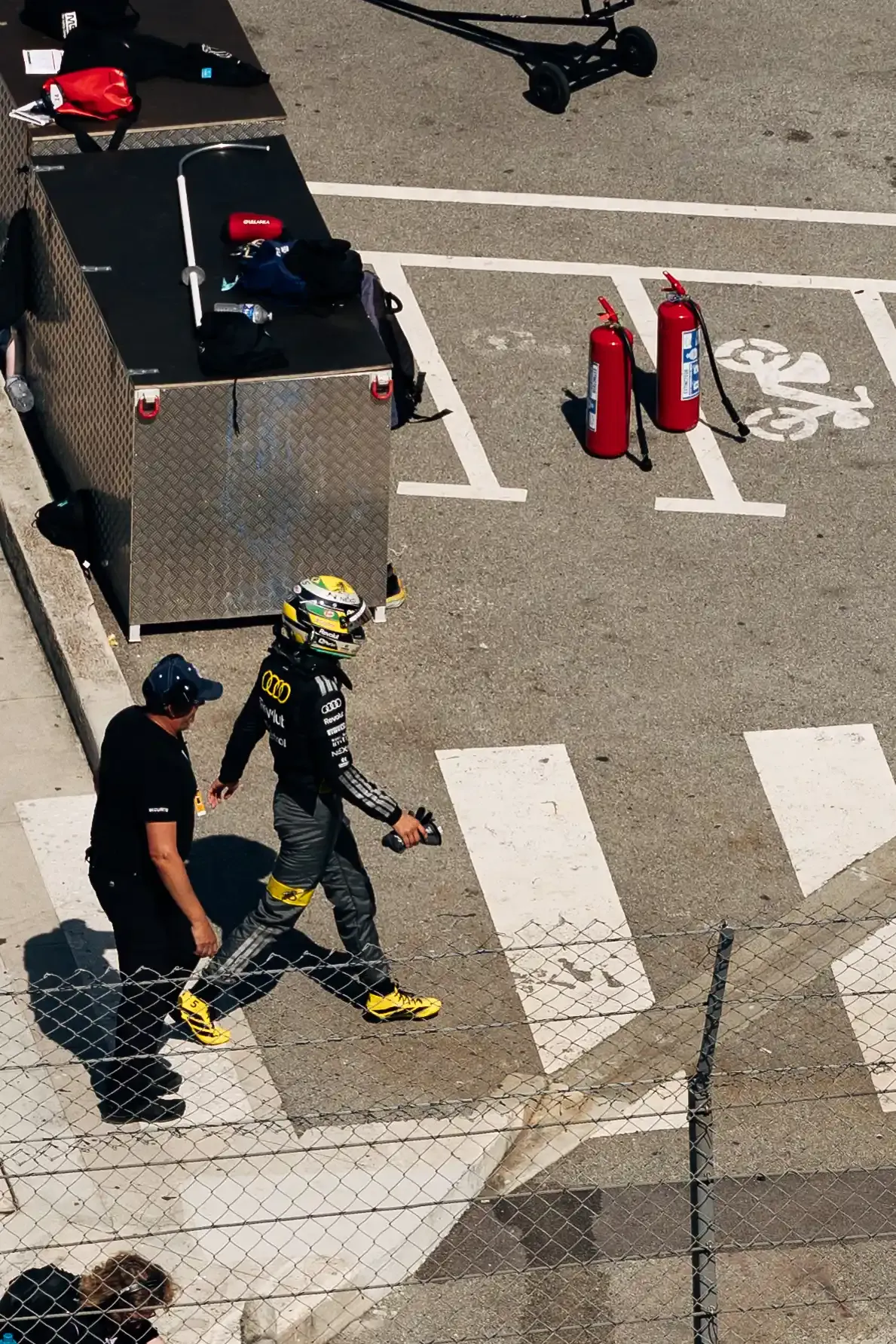 Audi Revolut F1® Team driver Gabriel Bortoleto walks through the Monaco paddock area in full race gear before qualifying.