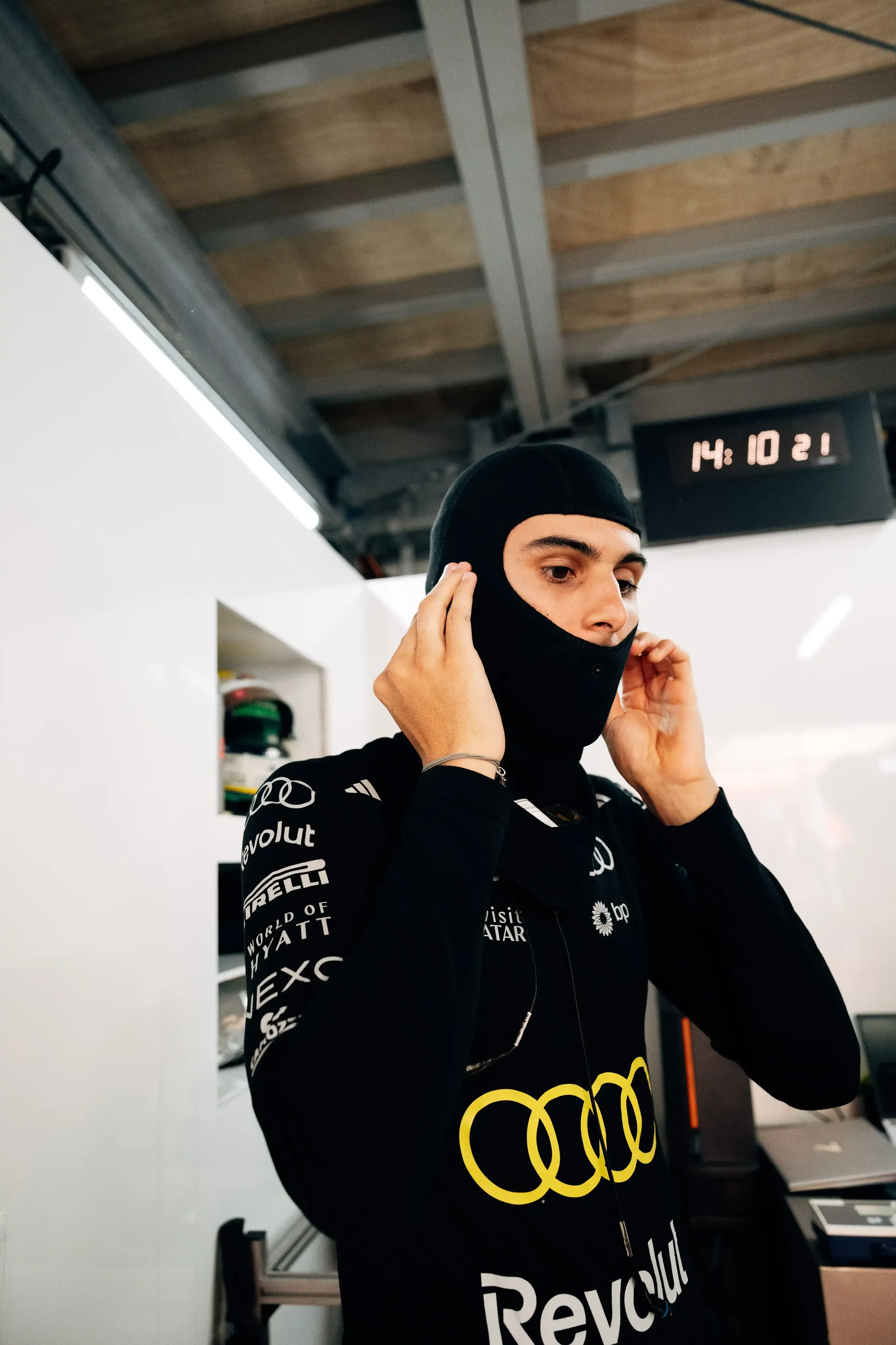Gabriel Bortoleto driver at the Audi Revolut F1® Team inside the garage putting on his mask at the Monaco Grand Prix 2026