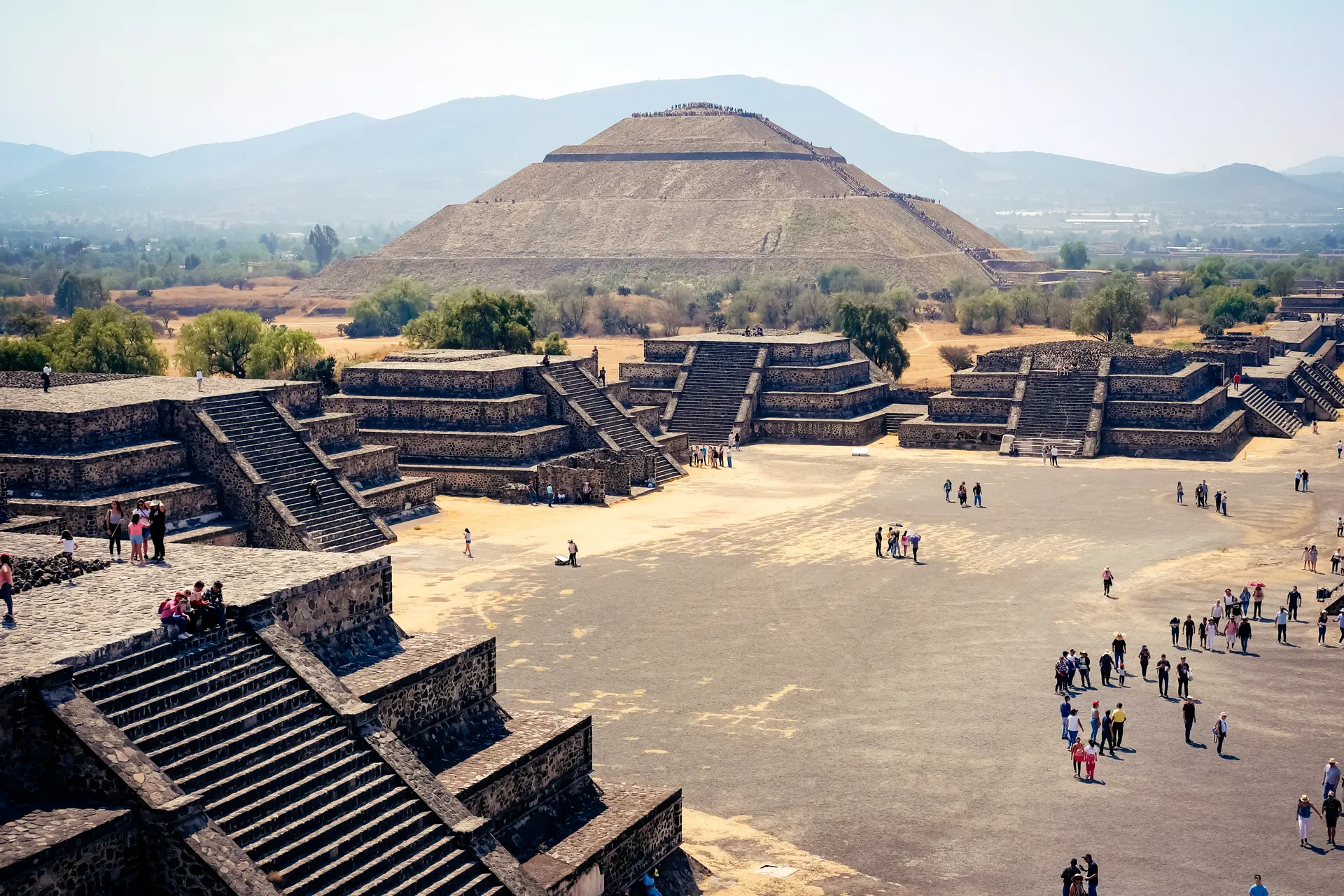 Visitors on the Avenue of the Dead with the Pyramid of the Sun in Teotihuacan near Mexico City