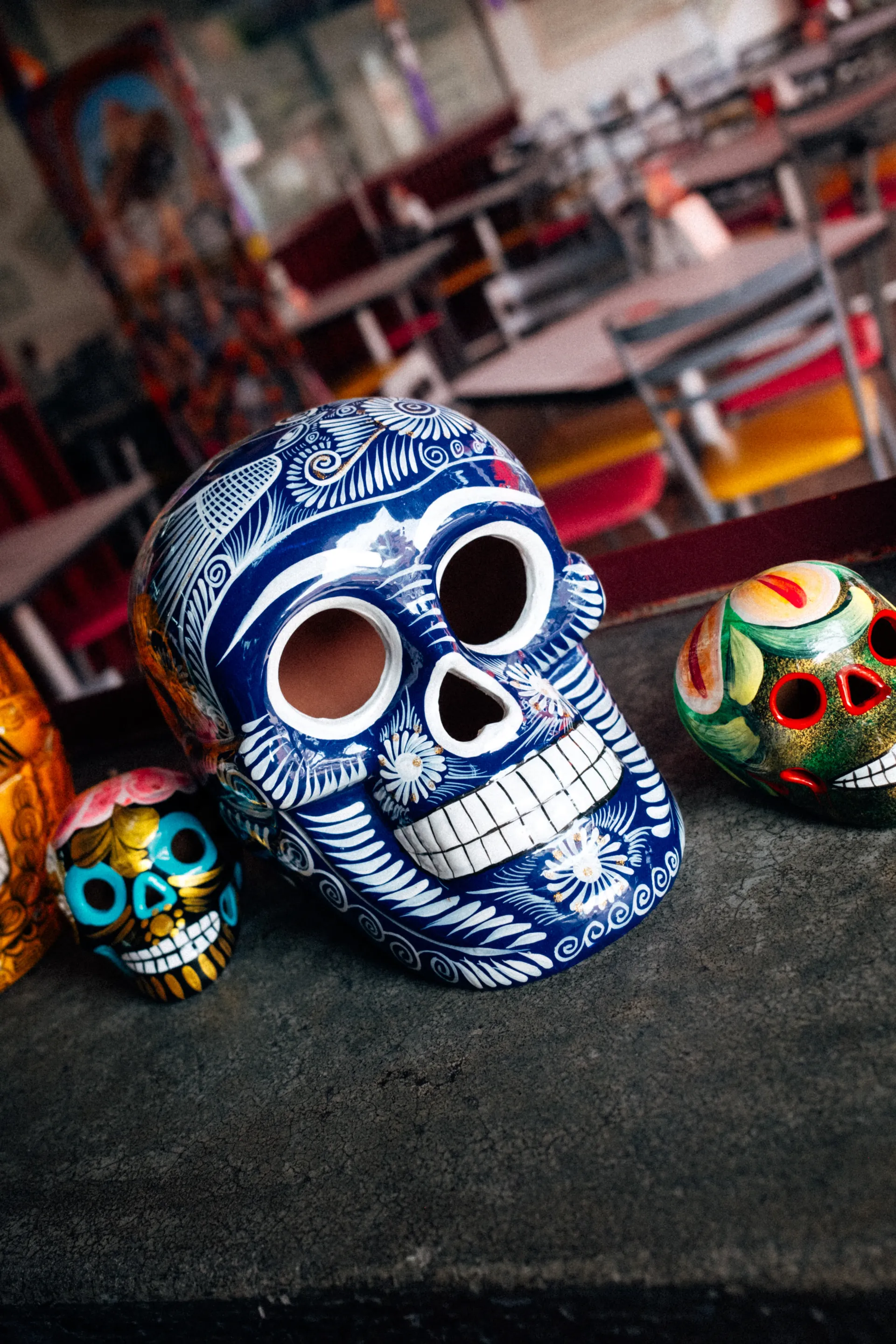 Hand-painted ceramic skulls on a table in a restaurant in Mexico City