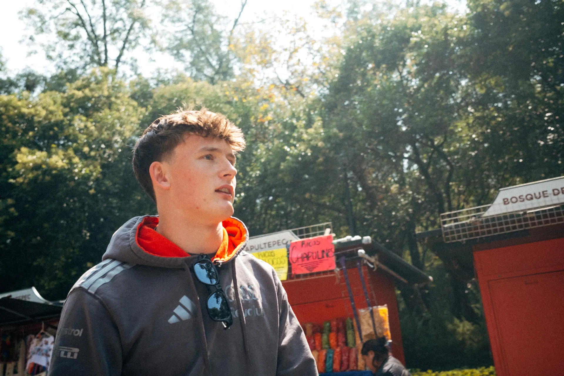 Freddie Slater in an Audi Revolut F1® Team hoodie looking up at the trees in Bosque de Chapultepec, Mexico City