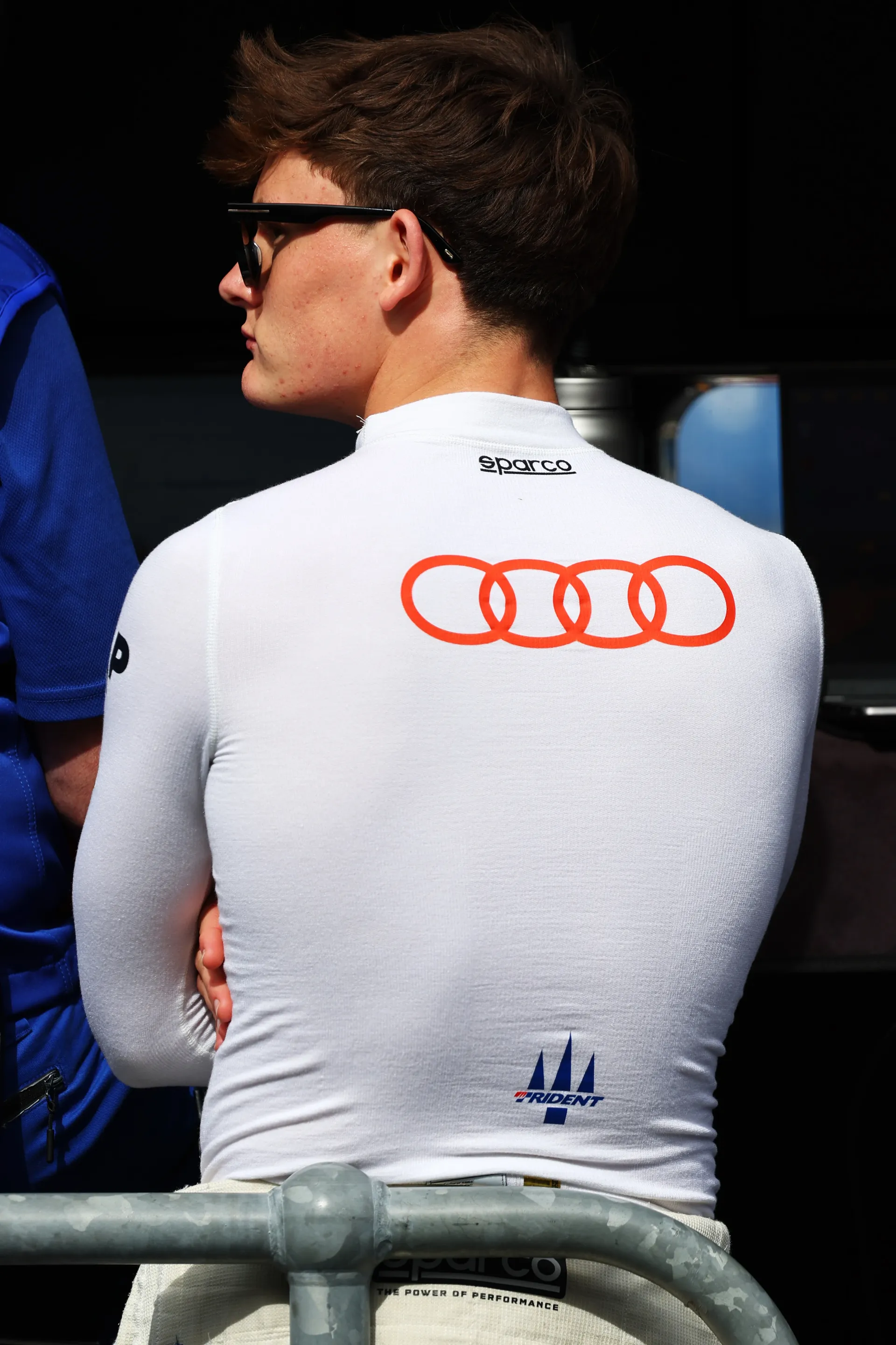 Freddie Slater seen from behind wearing Audi branded Sparco base layer in the Formula 3 paddock as part of the Audi Revolut F1® Team Driver Development Program