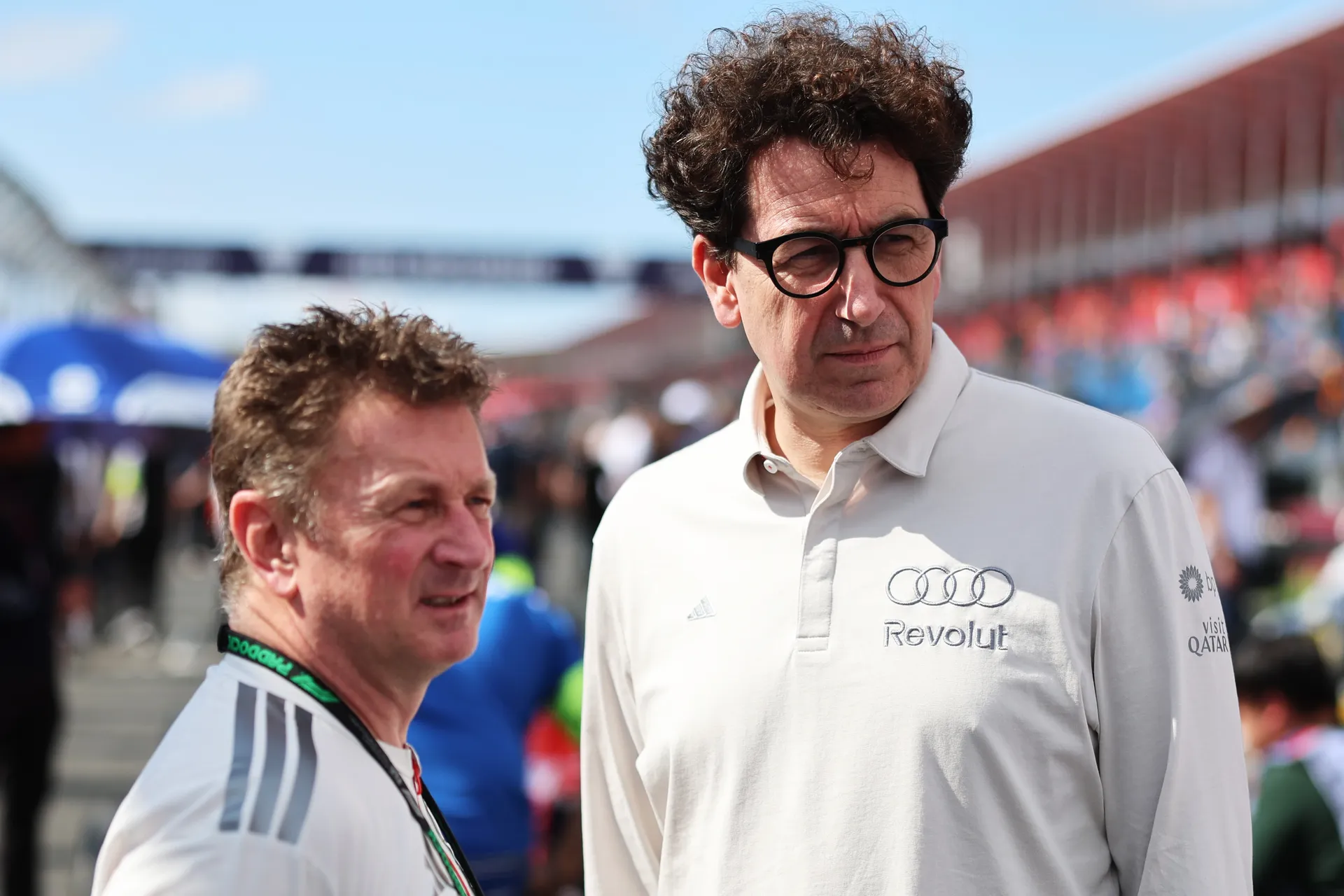 Mattia Binotto standing trackside with Allan McNish observing Formula 3 track action