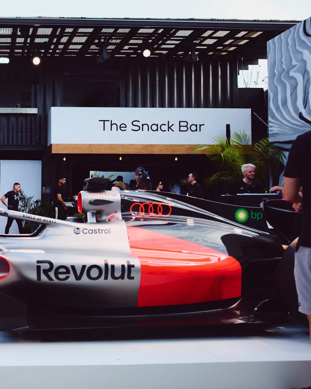 Side view of the Audi Revolut F1® Team show car outside The Snack Bar at the MAPS Backlot activation in Miami.