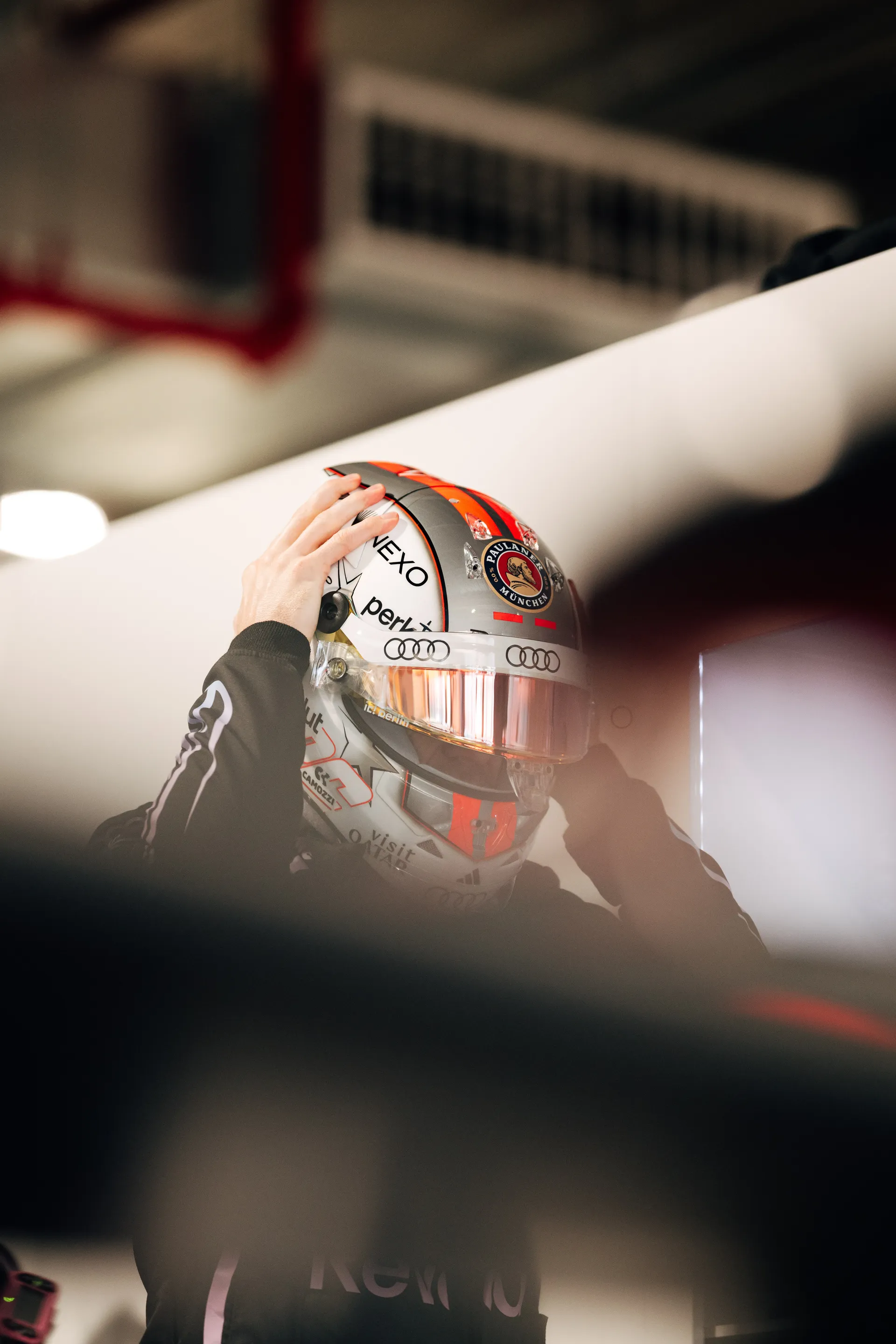 Nico Hulkenberg adjusts his helmet inside the garage before heading out for his session.