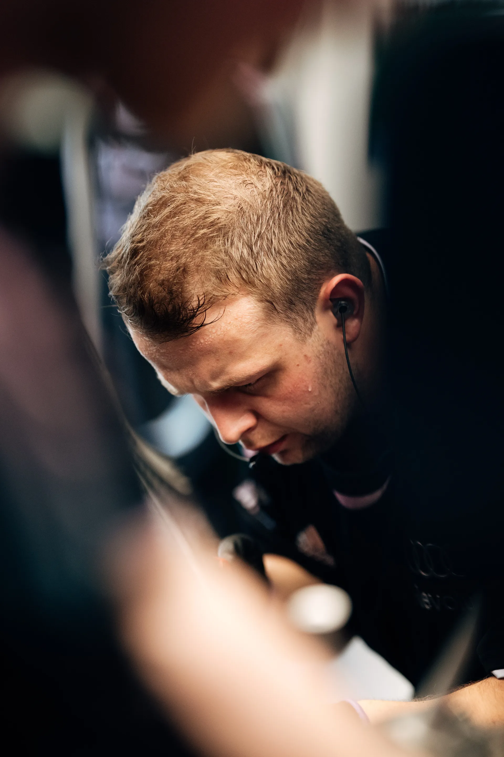 Audi Revolut F1® Team mechanic concentrates on technical work inside the garage environment.
