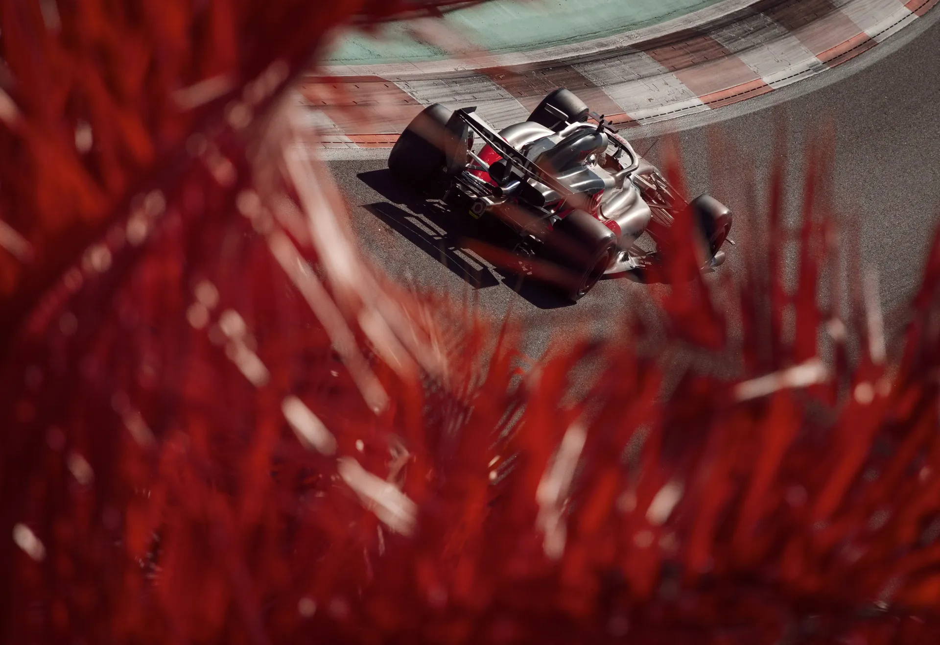 Audi Revolut F1® Team car seen through red foliage while cornering on Miami track