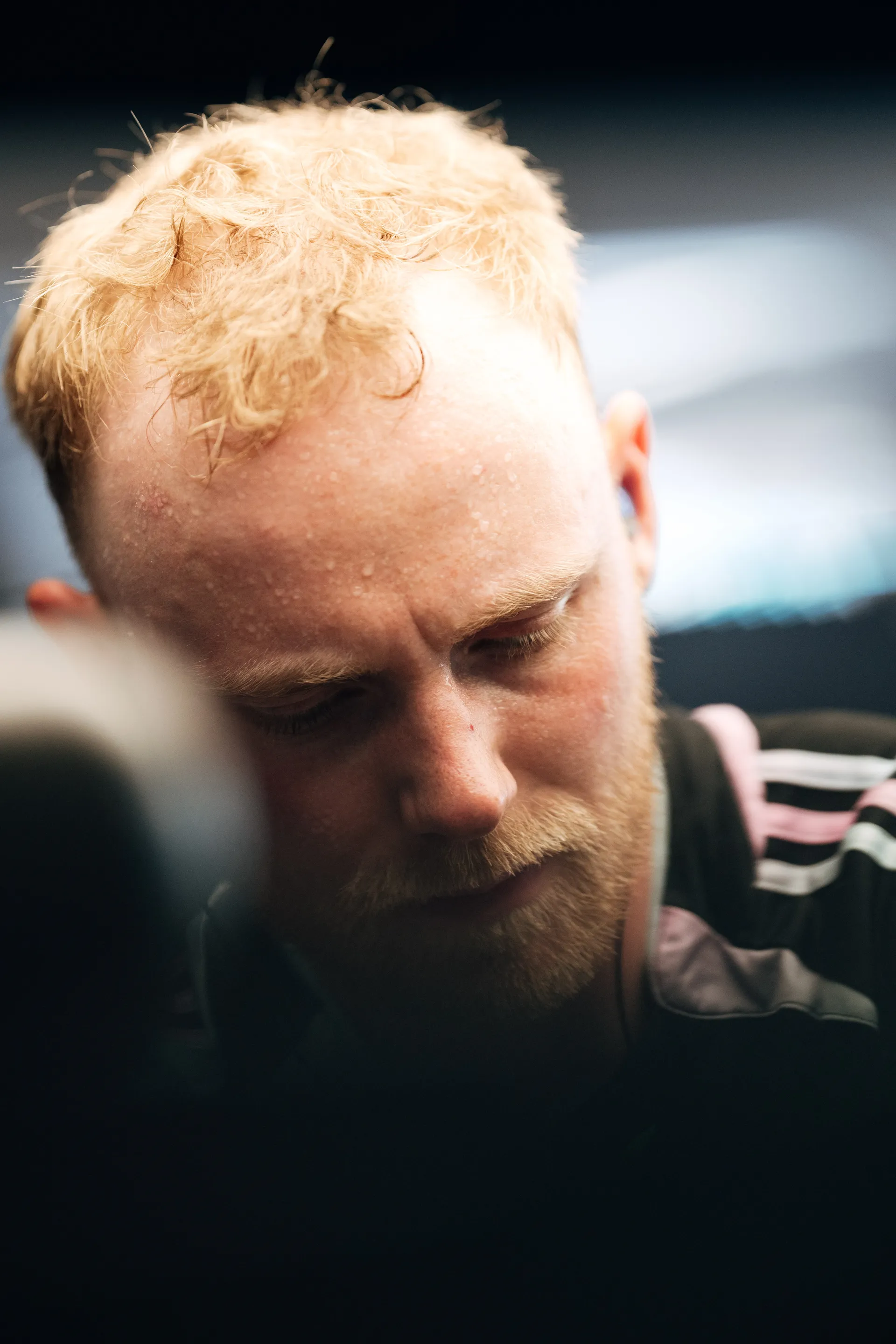 Close up of Audi Revolut F1® Team crew member with headset, focused during race preparation.