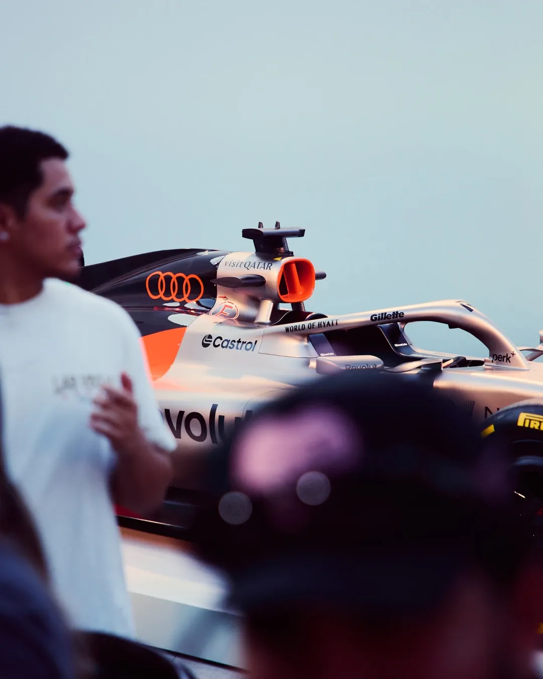 Audi Revolut F1® Team Formula 1 car displayed at the MAPS backlot event, viewed through a crowd of attendees