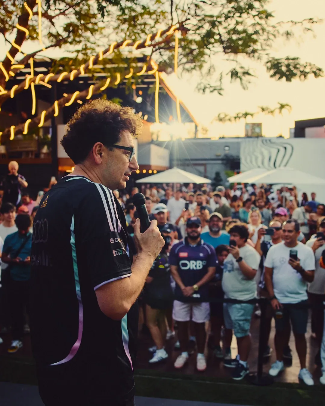 Audi Revolut F1® Team Mattia Binotto addressing a crowd of fans at the outdoor MAPS backlot event during sunset