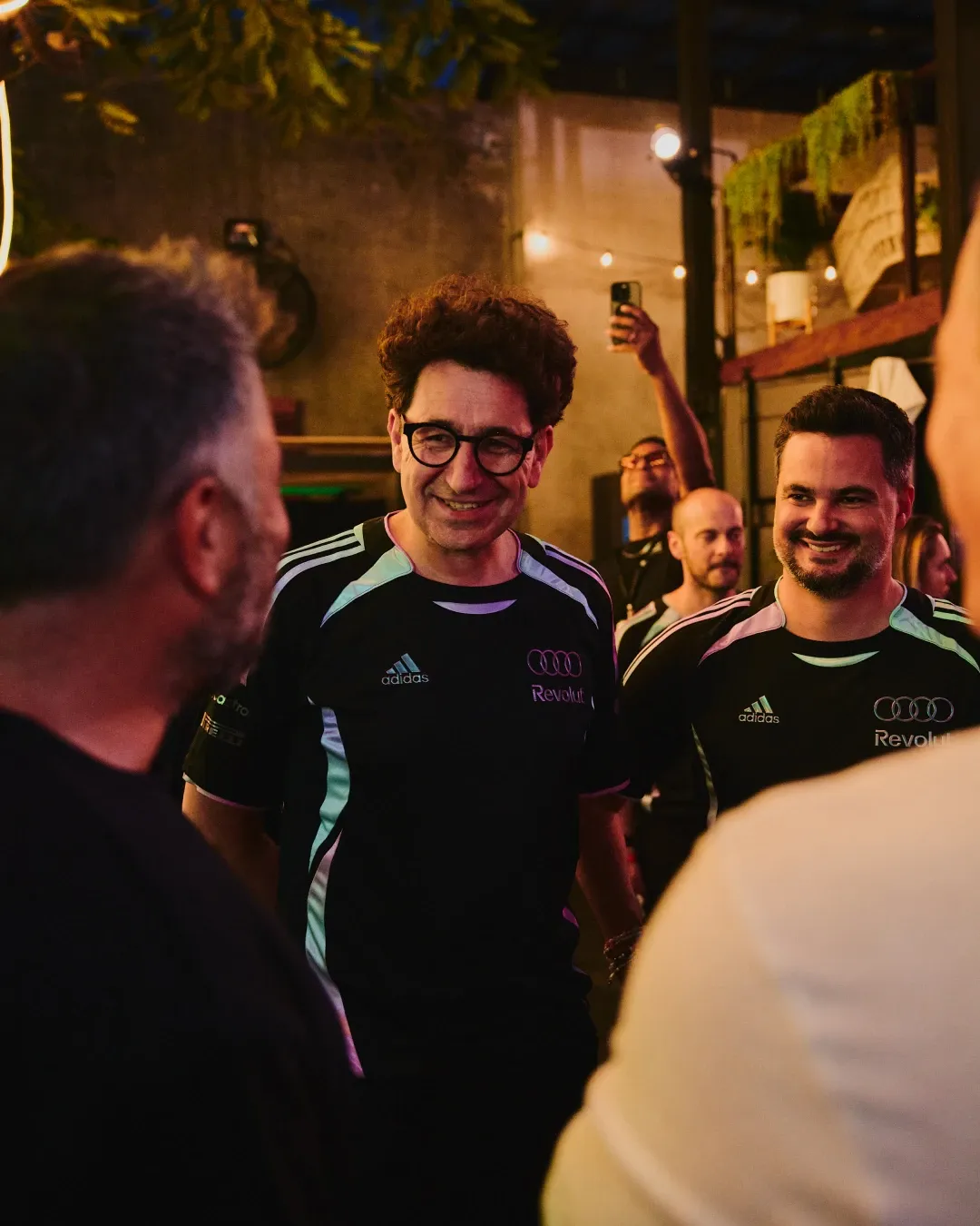 Audi Revolut F1® Team Mattia Binotto and staff interacting in a social setting during the evening activation event