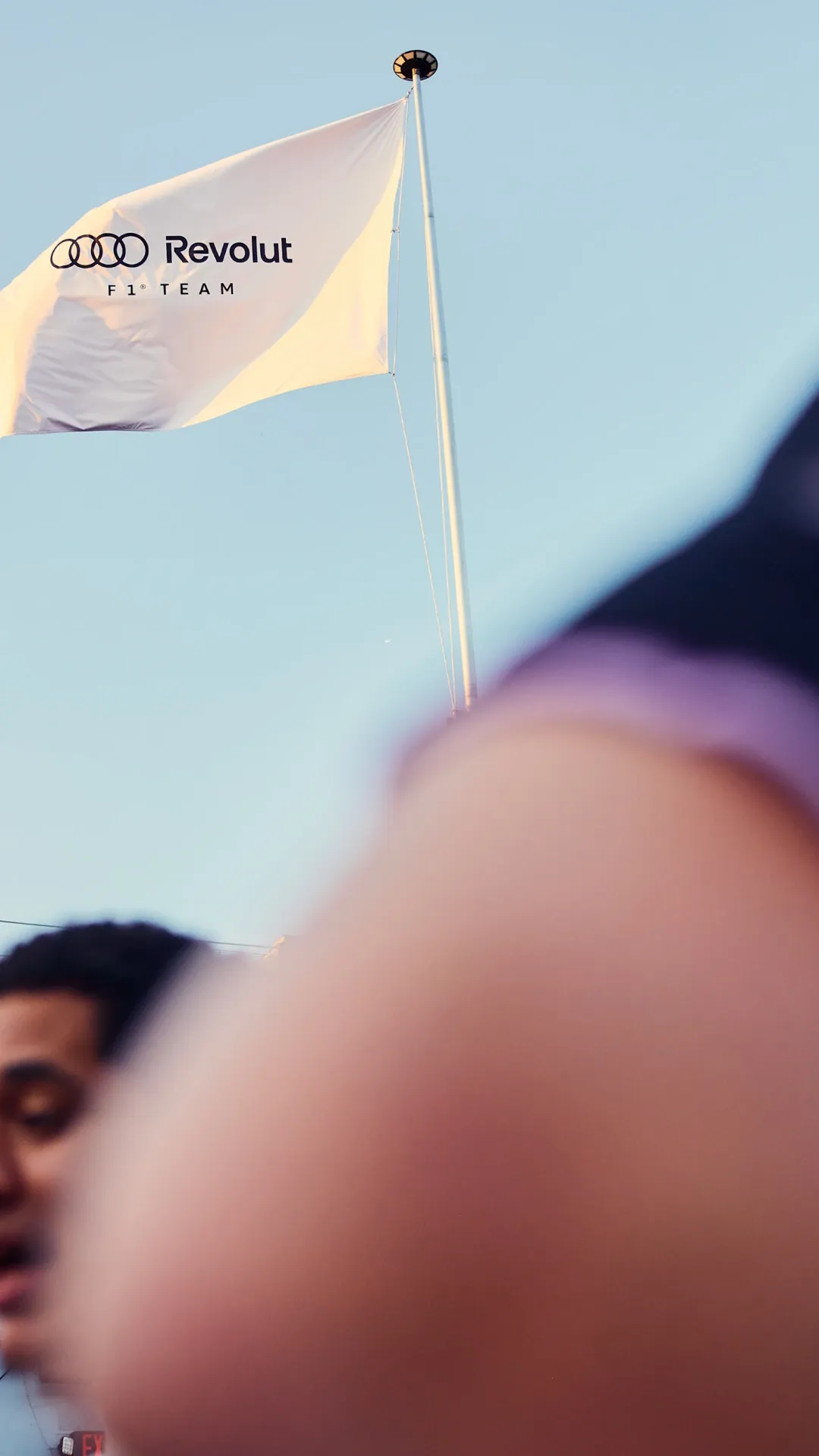 Audi Revolut F1® Team flag waving against the sky above the event venue