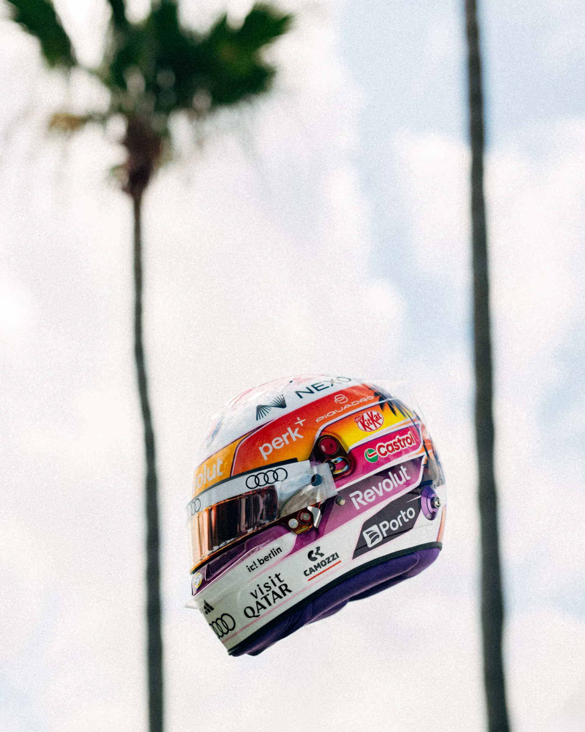 Gabriel Bortoleto’s special Miami edition race helmet floating between tall palm trees against a bright sky.