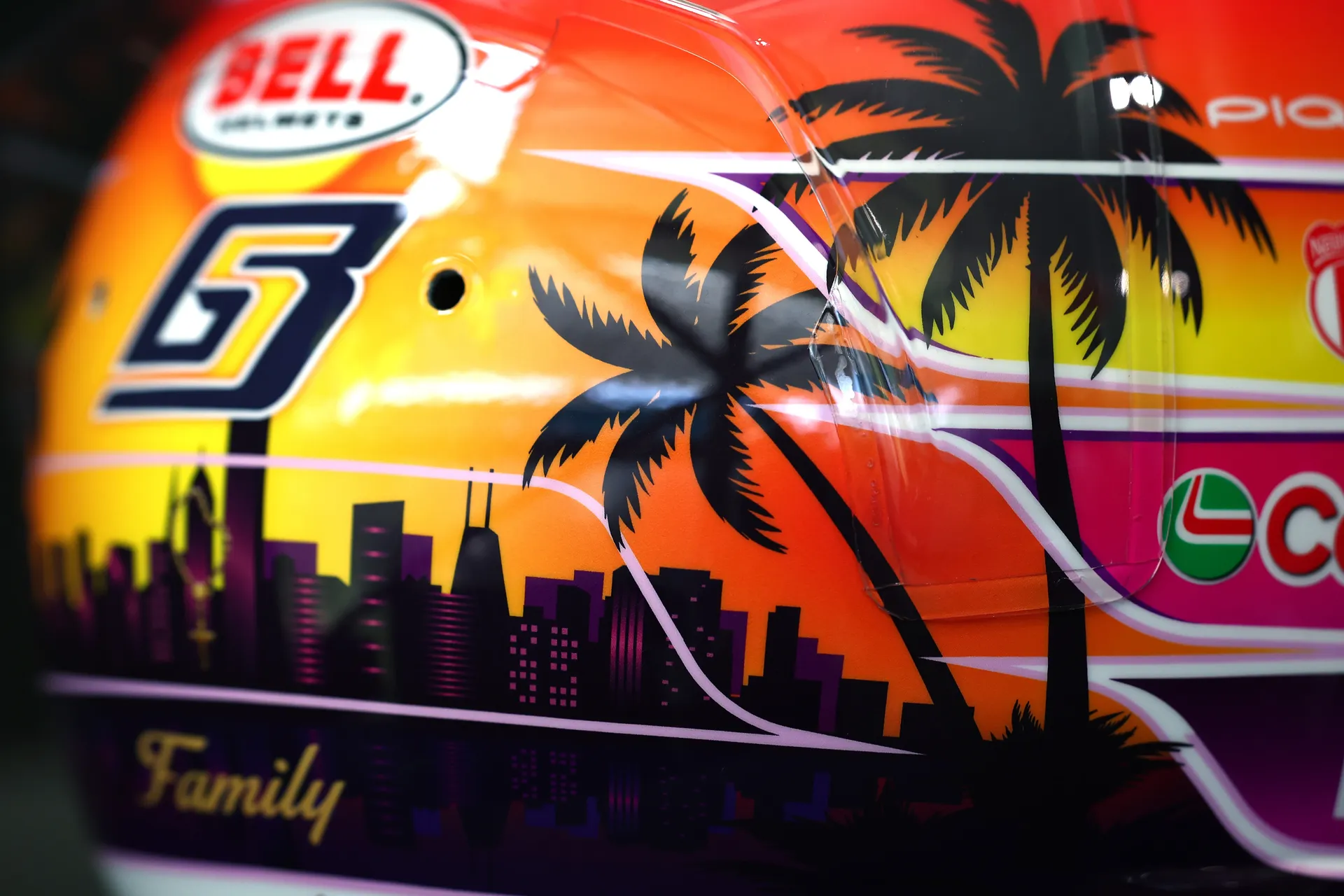 Rear-side close-up of Gabriel Bortoleto’s number 5 helmet design, highlighting palm trees, Miami skyline silhouette, and warm sunset tones.