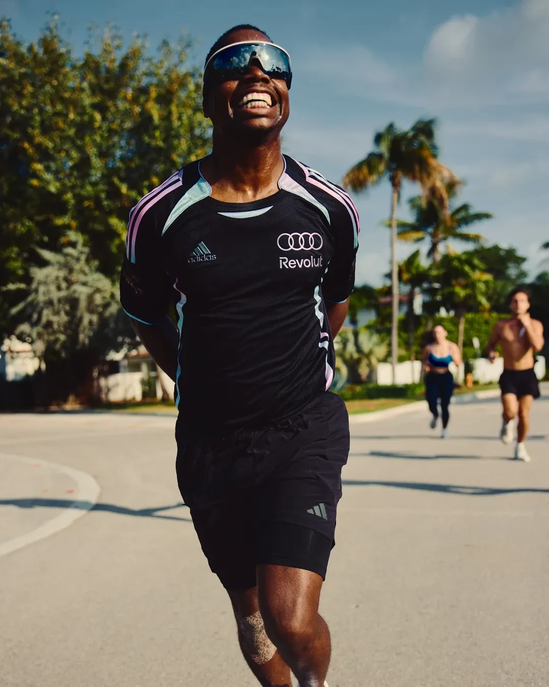 Runner moves forward with intensity during the adidas social run in Miami, wearing the special adidas Audi Revolut F1® Team Miami collection.