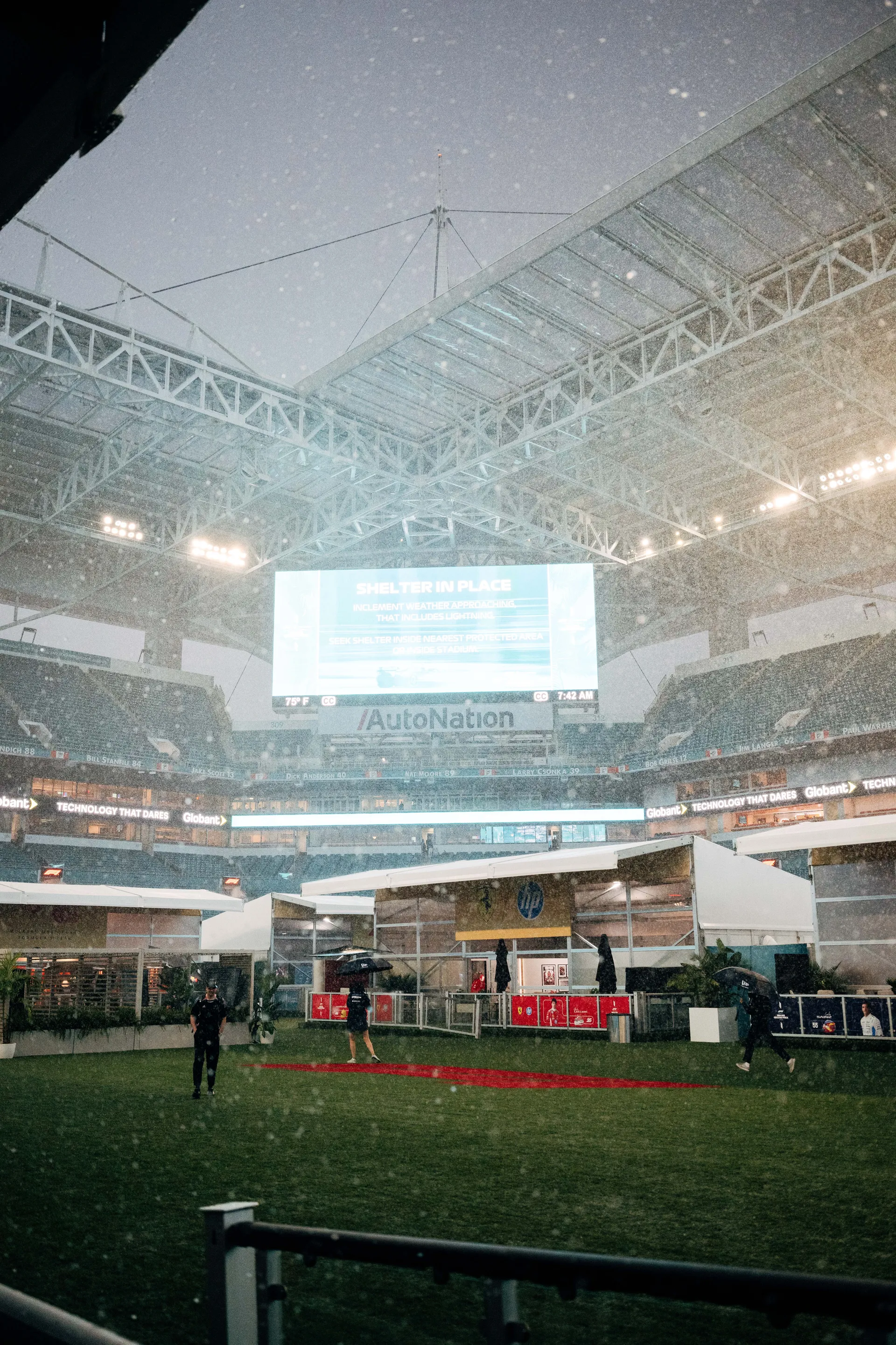 Heavy rain falls inside the Miami International Autodrome stadium as Audi Revolut F1® Team paddock structures are prepared during the 2026 Miami Grand Prix weekend.